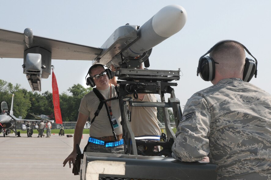 During Operation Grandstand, Staff Sgt. Joe McIlhon (left) and Senior Airman Benjamin Rogers (right) load missiles onto an F-16C aircraft on the west ramp of the 132nd Fighter Wing in Des Moines, Iowa, on August 6, 2010.  The 132nd Fighter Wing is conducting Operation Grandstand in preparation for the Operational Readiness Inspection which will be in October.  (US Air Force photo/Staff Sgt. Linda E. Kephart)(Released)