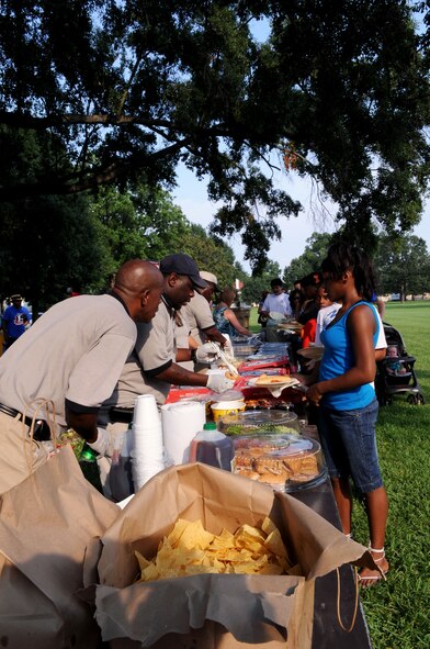 BARKSDALE AIR FORCE BASE, La. -- Volunteers serve the crowd as they come through the food line during Barksdale's third annual National Night Out Aug. 3. More than 100 participants and volunteers came out for the event. (U.S. Air Force photo by Senior Airman La'Shanette V. Garrett)(RELEASED)