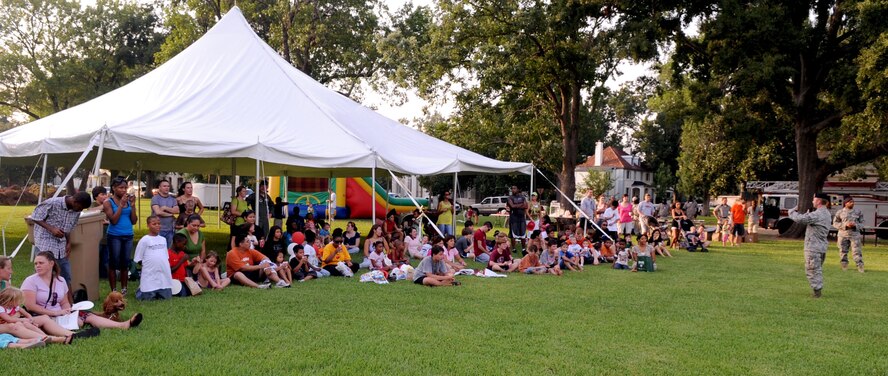 BARKSDALE AIR FORCE BASE, La. -- Staff Sgt. Daniel Craig, 2d Security Forces Squadron military working dog trainer, goes over some safety rules with the crowd before the K-9 demonstration during the National Night Out Aug. 3. More than 100 participants and volunteers came out for Barksdale's third annual National Night Out. (U.S. Air Force photo by Senior Airman La'Shanette V. Garrett)(RELEASED)