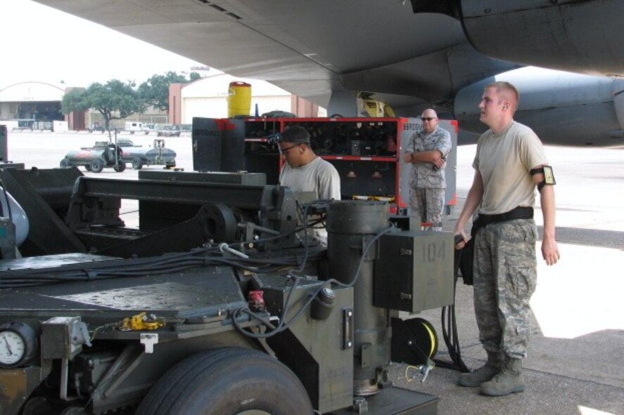 BARKSDALE AIR FORCE BASE, La. -- Col. Charles Johnson (center), 2d Maintenance Group commander, looks on as Staff Sgt. Daniel Santell (right) and Staff Sgt. Jose Baez-Sauri, perform a practice conventional load in preparation for the Air Force Global Strike Command Challenge. (courtesy photo)