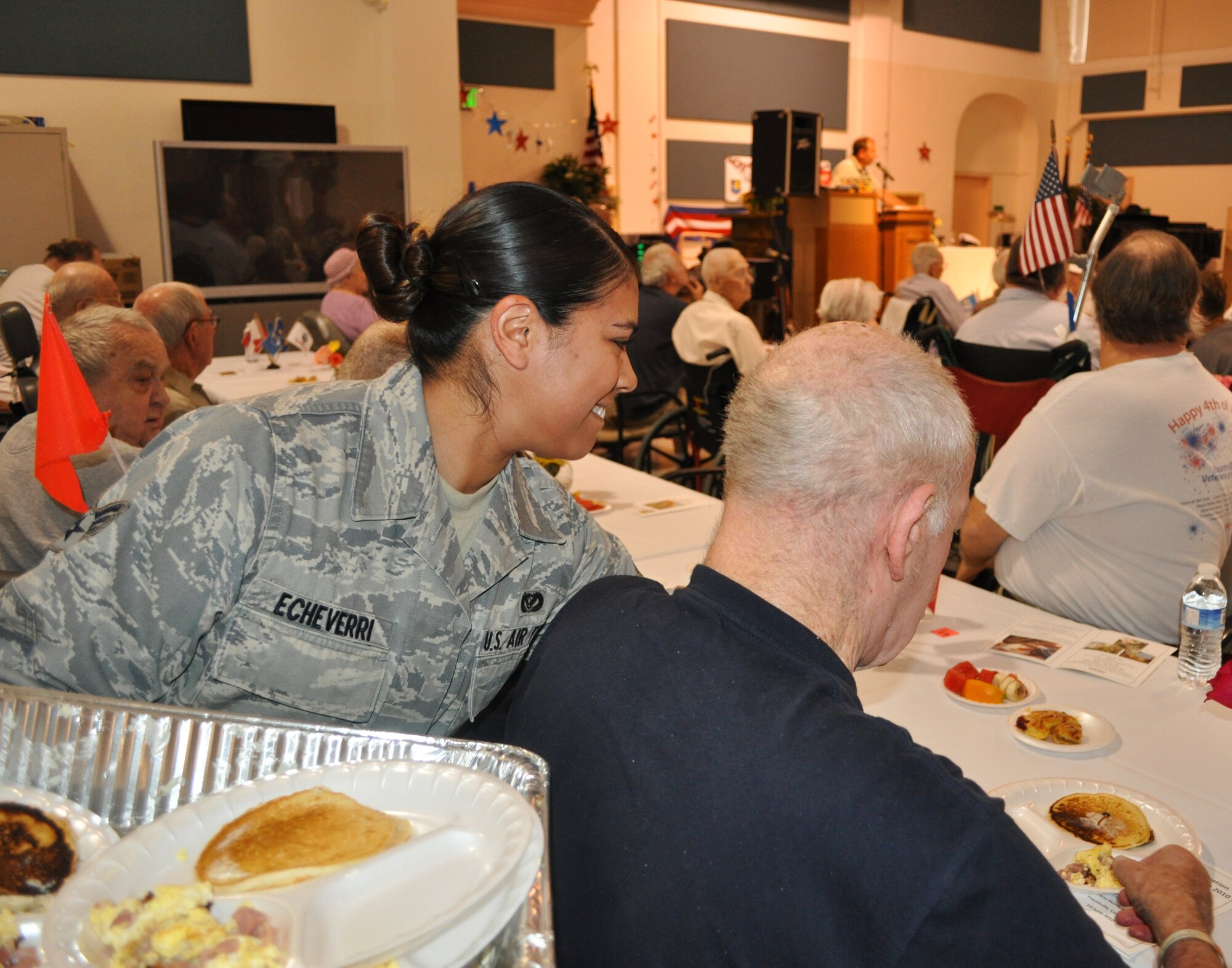 Senior Airman Vanessa Echeverri, 349th Civil Engineer Squadron, serves brunch to a veteran at the Yountville California Veterans Home. (U.S. Air Force photo)