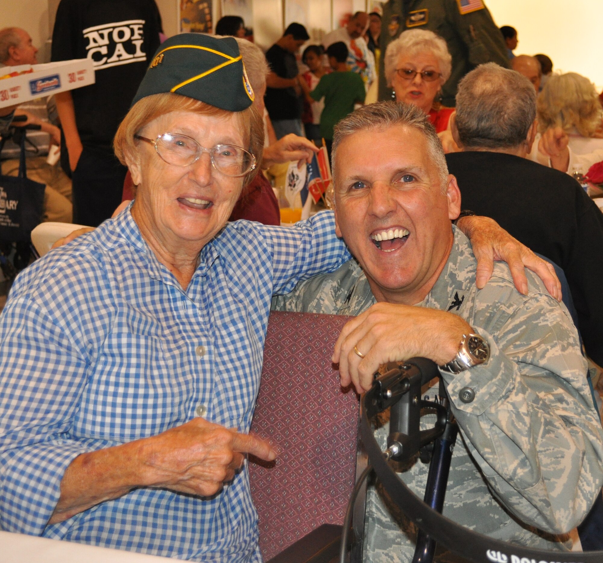 Col. Jay Flournoy, 349th Air Mobility Wing commander, shares a laugh with a U.S. Coast Guard veteran during the 10th annual Operation Gratitude champagne brunch sponsored by 349th AMW Airmen. (U.S. Air Force photo)