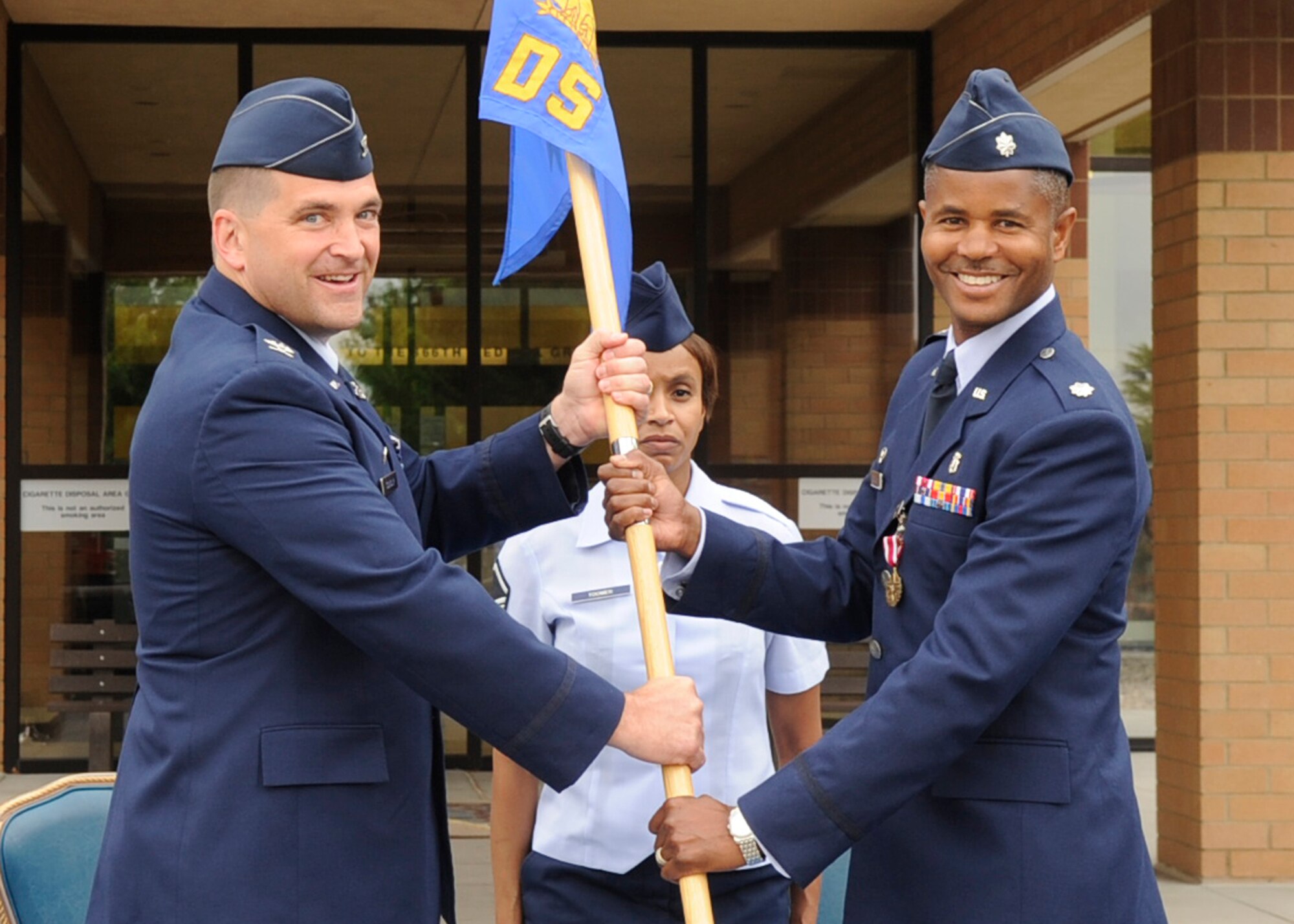 MOUNTAIN HOME AIR FORCE BASE, Idaho - Lt. Col. Cathey, outgoing commander of the 366th Dental Squadron, surrenders the guideon during the DS change of command held in front of the hospital June 29. The command was passed on to Lt. Col. Robin Fontenot. (U.S. Air Force Photo by Airman 1st Class Angelina Drake)