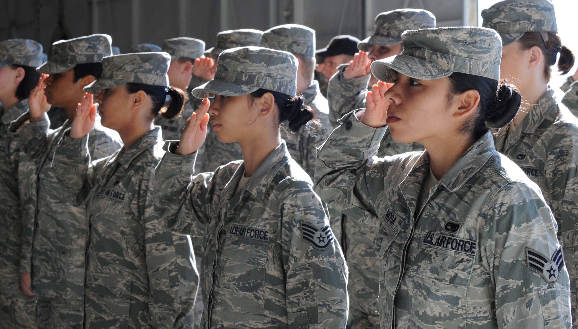MOUNTAIN HOME AIR FORCE BASE, Idaho -- Senior Airman Cindy Rosa, 366th Maintenance Operation Squadron, salutes with her fellow Airmen during a Change of Command Ceremony for MOS  in hangar 1331 June 17. The ceremony was presided over by Col. James Fowler.(Airman 1st Class Debbie Lockhart)