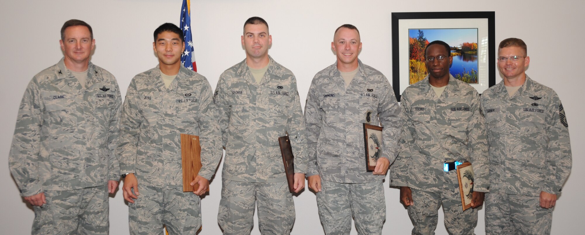 Diamond Sharp award winners, U.S. Air Force Senior Airman George Jang, 27th Special Operations Support Squadron, U.S. Air Force Airman 1st Class David George, 27th Special Operations Equipment Maintenance Squadron, U.S. Air Force Senior Airman Christopher Simmons 27th Special Operations Security Forces Squadron, and Senior Airman Ron Cooke, 27th Special Operations Component Maintenance Squadron, stand with U.S. Air Force Col. Stephen Clark (left), 27th Special Operations Wing commander, and U.S. Air Force Chief Master Sgt. William Turner (right), 27 SOW command chief following the monthly Diamond Sharp breakfast at The Landing Zone at Cannon Air Force Base, N.M., Aug. 6, 2010. Diamond Sharp Airmen are selected monthly by Cannon's first sergeants to recognize Airmen who exemplify Air Force standards of conduct and performance. (U.S. Air Force photo by Airman 1st Class Maynelinne De La Cruz)(Released) 
