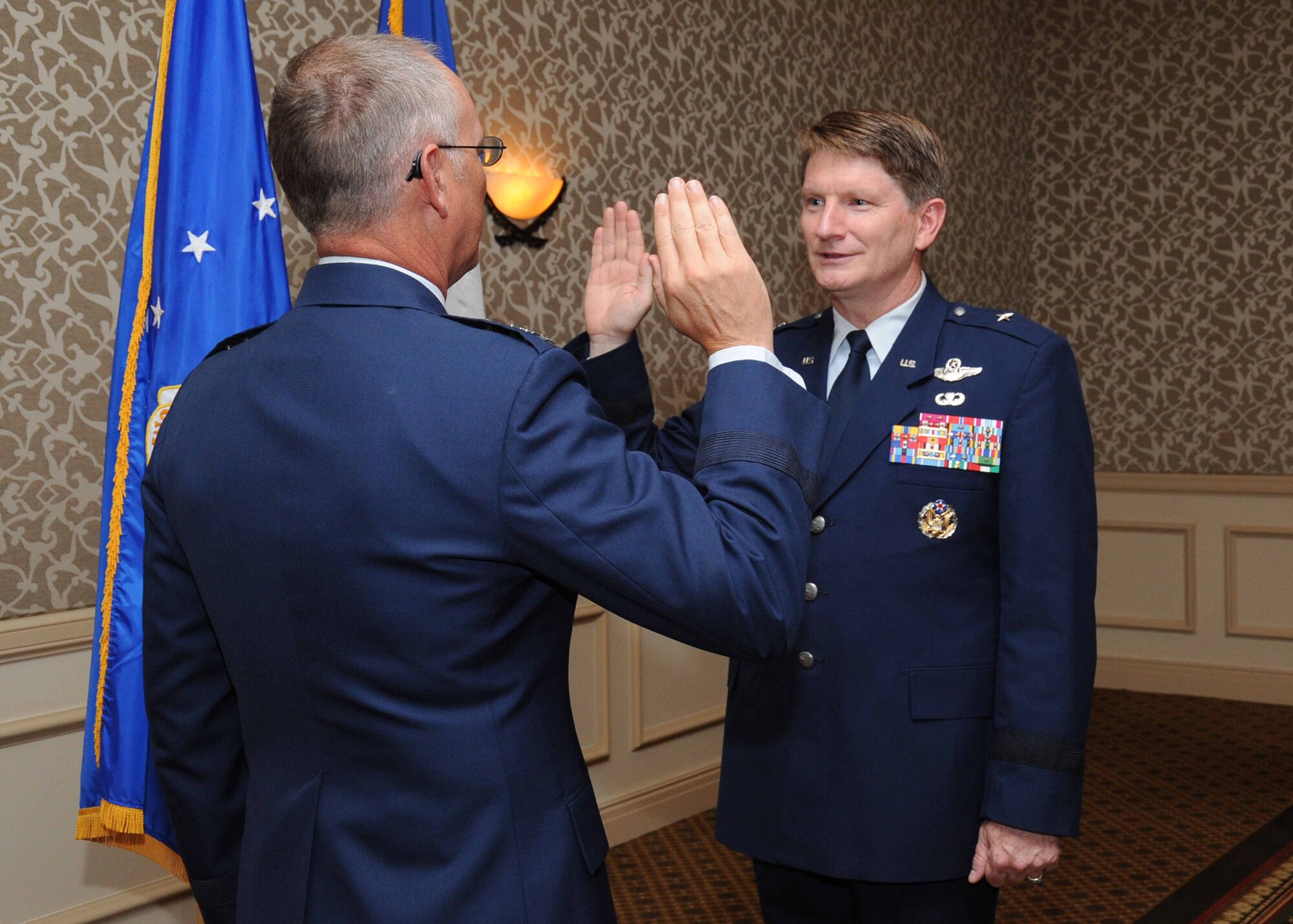 Lt. Gen. Robert R. Allardice, 18th Air Force commander, officates the pinning-on ceremony of Brig. Gen. Robert D. Thomas, 15th Ecpeditionary Mobility Task Force commander Aug. 2 at the Omni Hotel in San Antonio. General Thomas recently took over as the 15th EMTF commander during a July 15 change-of-command ceremony. (U.S. Air Force photo/Alan Boedeker)