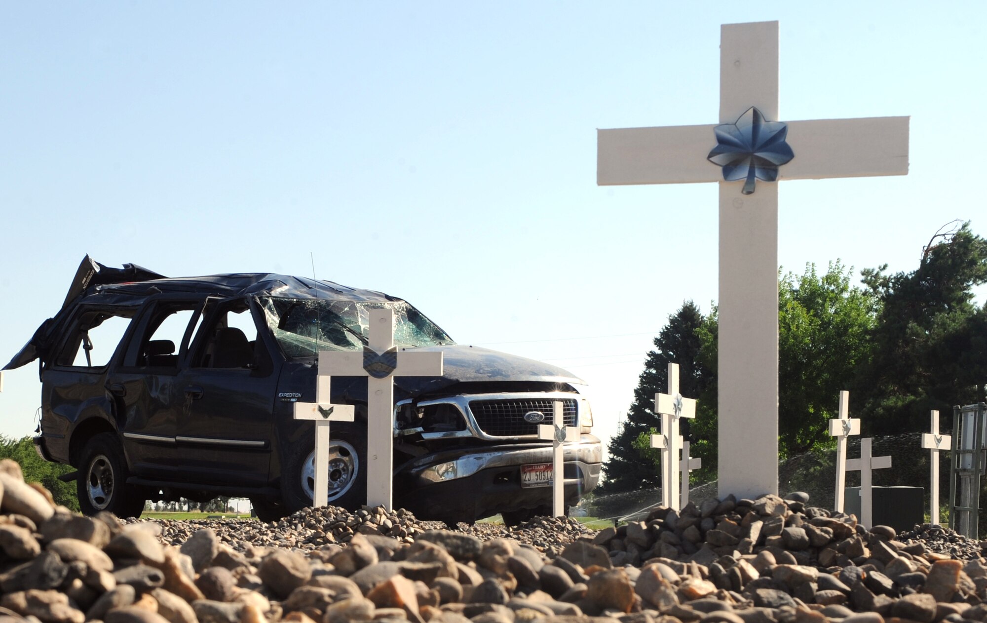 MOUNTAIN HOME AIR FORCE BASE, Idaho -- Buckle up and survive. The Critical Days of Summer traffic safety display has been relocated and refreshed. Since the crosses and vehicle were put in place on 26 May the safety office has added 9 crosses for recent Air Force fatalities: 1-Airman; 4-Airman First Class; 1-Staff Sergeant; 2-Technical Sergeants; 1-Lt Colonel.  (U.S. Air Force photo by Airman 1st Class Debbie Lockhart)