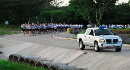 SOTO CANO AIR BASE, Honduras --  Joint Security Forces members escort Joint Task Force-Bravo as they participate in the JTF-Bravo Run here Aug. 6. The group is followed up by an ambulance to ensure the safety of the runners. (U.S. Air Force photo/Tech. Sgt. Benjamin Rojek)