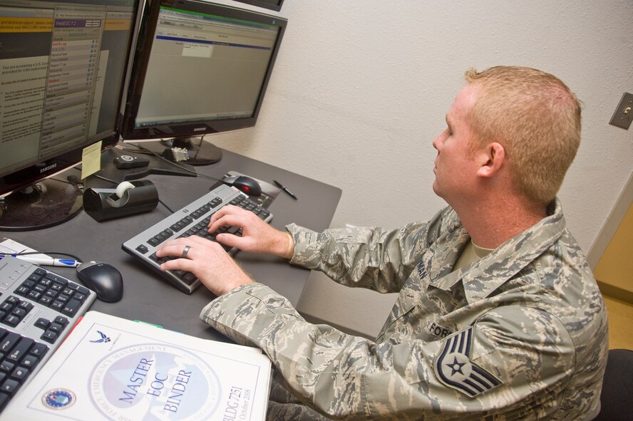Staff Sgt. Brandon Layman, 2d Civil Engineer Squadron, emergency management non commissioned officer in charge, updates information during an emergency operations center recall exercise. When recalled, the EOC members work behind-the-scenes of any on-base or local incident as a key focal point in getting incident commanders the recourses they need to remedy the situation. (U.S. Air Force photo by Senior Airman Brittany Y. Bateman)(RELEASED)