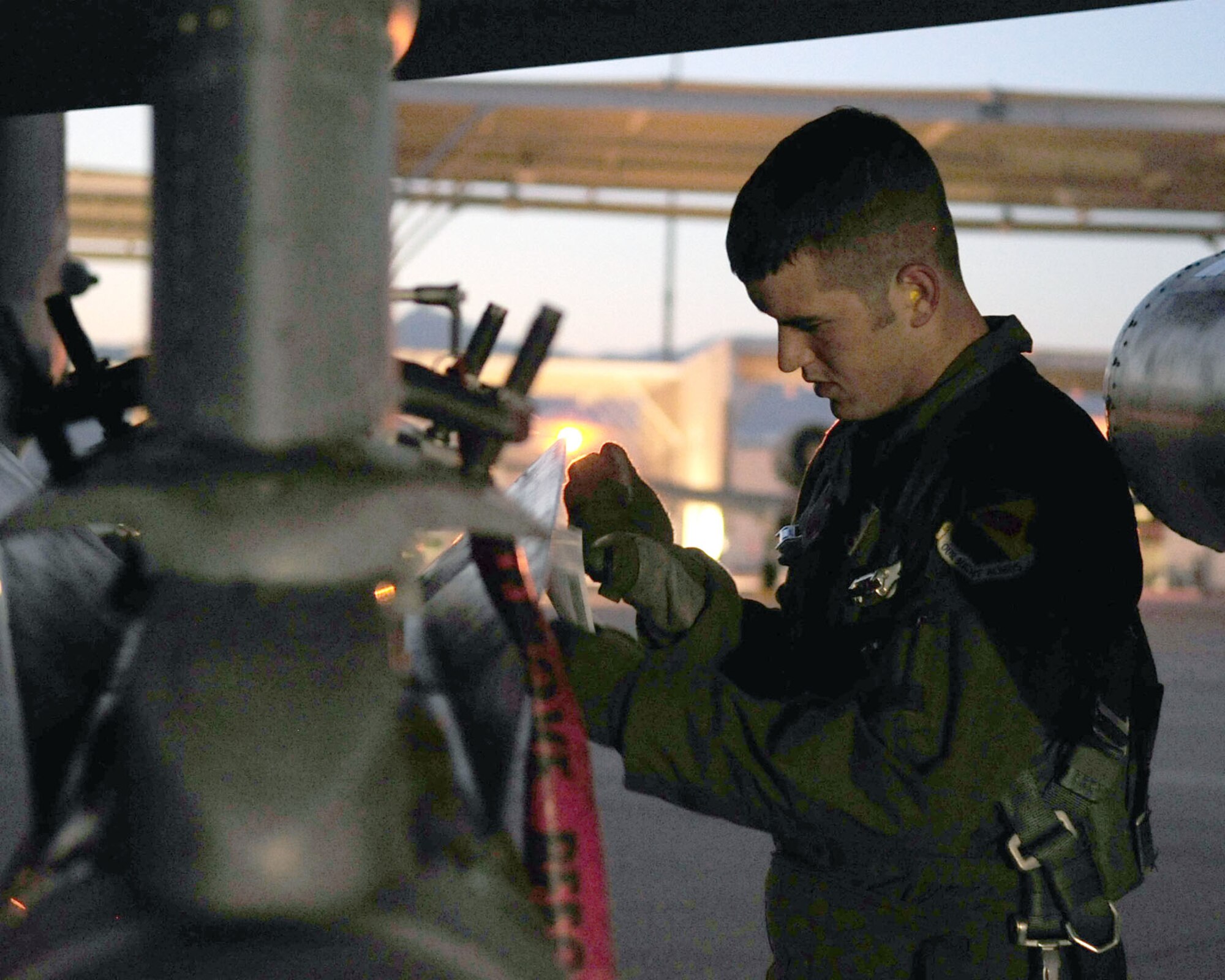 Prior to a training flight June 23, 2010, 1st Lt. Dan Griffin, a pilot from the 358th Fighter Squadron at Davis-Monthan Air Force Base, Ariz., inspects his A-10C Thunderbolt II aircraft. This was the lieutenant's second of eight night flying missions as part of the A-10C Pilot Initial Qualification course curriculum. Upon completion of this course he will be a fully qualified A-10C pilot.  (U.S. Air Force photo/Airman 1st Class Jerilyn Quintanilla)