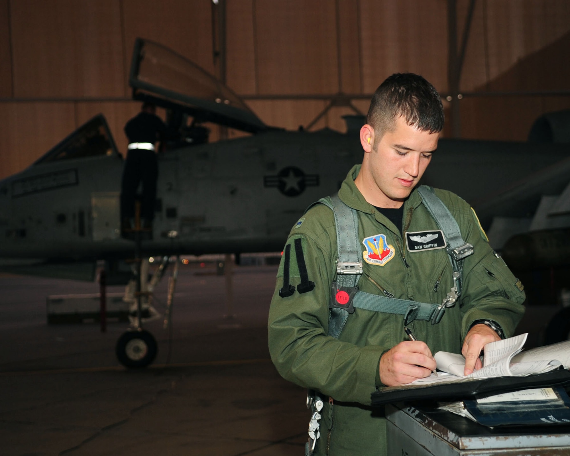 Prior to a training flight June 23, 2010, 1st Lt. Dan Griffin, a pilot from the 358th Fighter Squadron at Davis-Monthan Air Force Base, Ariz., reviews maintenance records for the A-10C Thunderbolt II he'll be flying. This was the lieutenant's second of eight night flying missions as part of the A-10C Pilot Initial Qualification course curriculum. Upon completion of this course he will be a fully qualified A-10C pilot. (U.S. Air Force photo/Airman 1st Class Jerilyn Quintanilla)