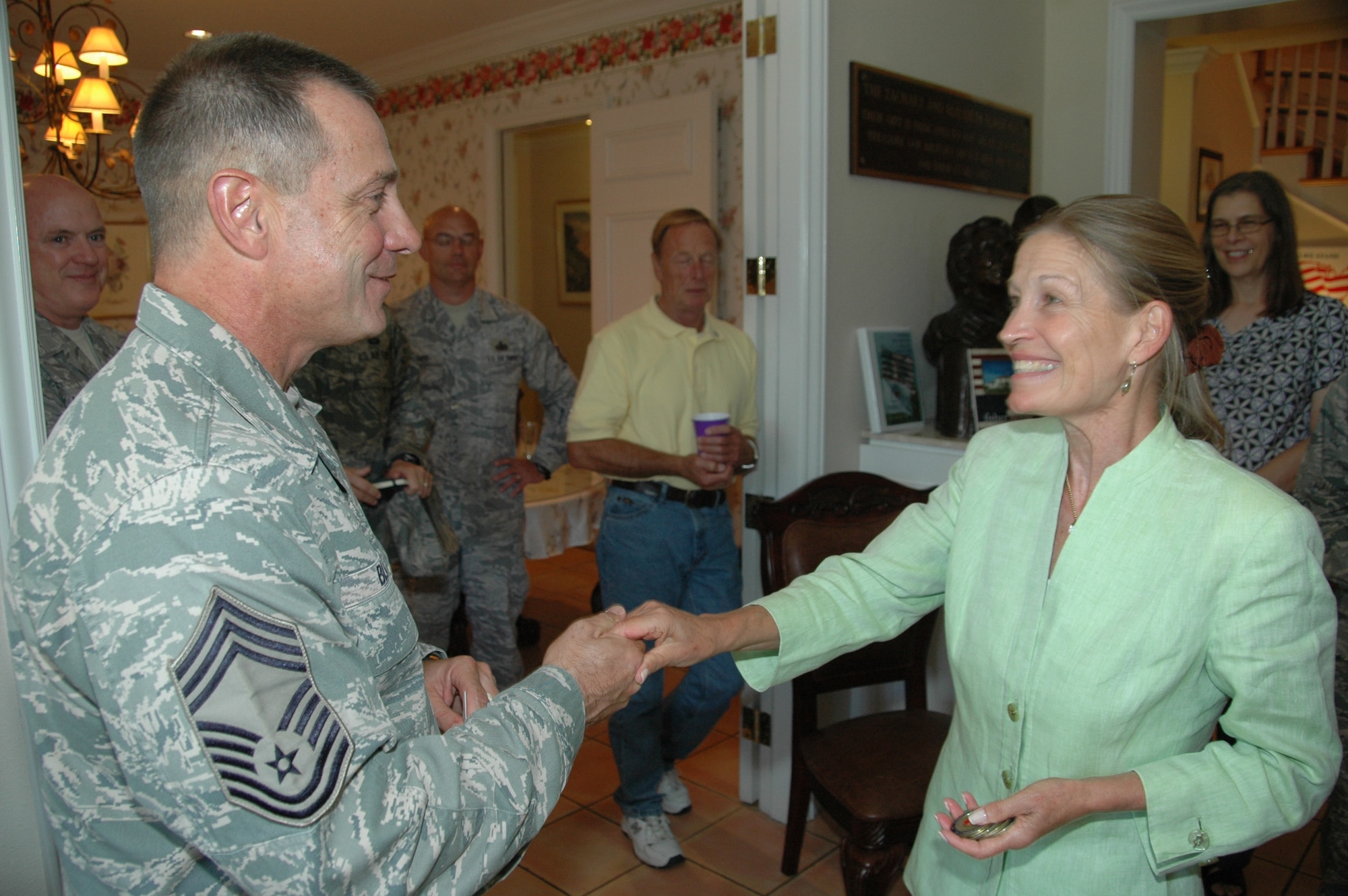 Chief Master Sgt. Larry Blake, 60th Medical Group superintendent accepts a Fisher House coin from Mrs. Audrey Fisher, vice chair of the Fisher House Foundation board of directors during a visit to the Travis Fisher House.  Mrs. Fisher, along with two other “roving ambassadors” visited Travis Fisher House Aug. 4 as part of a five-day, five stop tour of Fisher Houses in Washington and California (U.S. Air Force photo /Jim Spellman)

 

 
