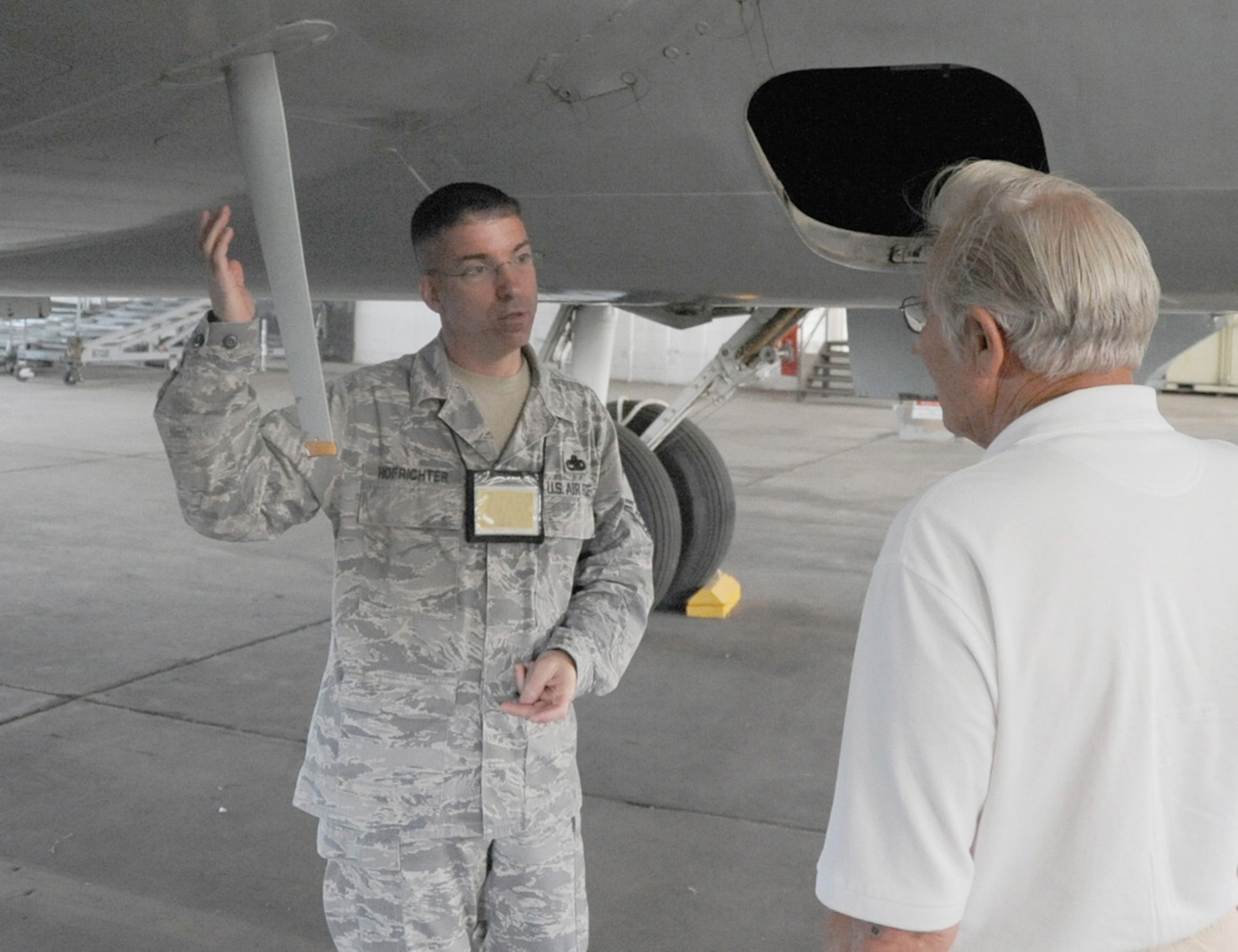JOINT BASE MCUIRE-DIX-LAKEHURST, N.J. -- Senior Master Sgt. Christopher Hofrichter shows retired flight mechanic John Wehrman around the C-118, Aug. 3, 2010. Wehrman was a crewmember on the aircraft when it was in service. Hofrichter is a member of the 514th Maintenance Group and project manager for the restoration efforts of the C-118, which is usually on display in front of the McGuire passenger terminal. (U.S. Air Force photo/James Hodges)