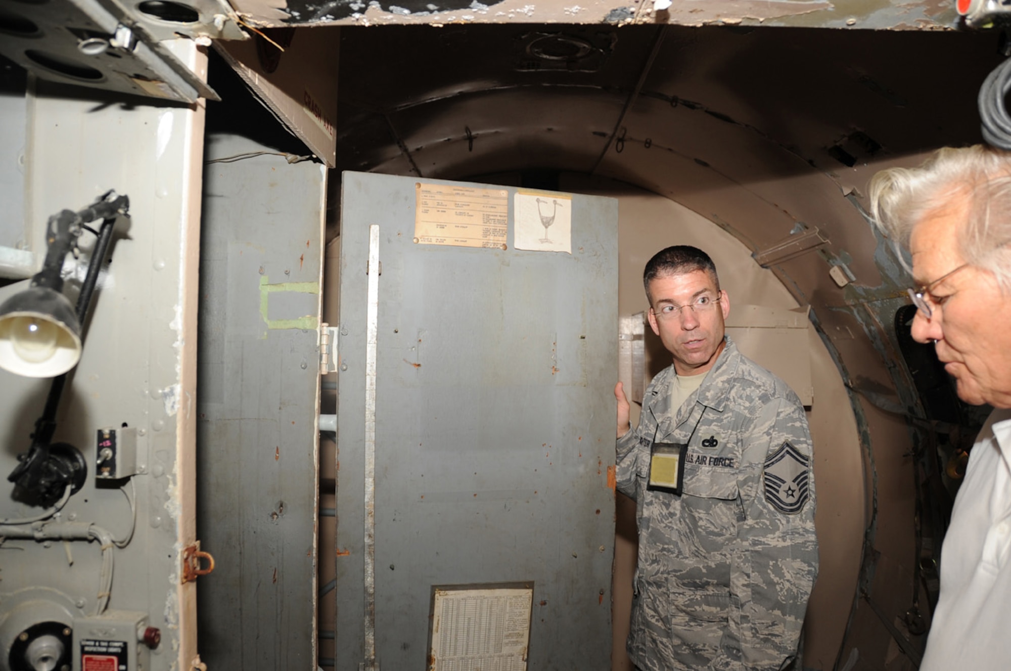 JOINT BASE MCUIRE-DIX-LAKEHURST, N.J. -- Retired flight mechanic John Wehrman describes to Senior Master Sgt. Christopher Hofrichter, Aug. 3, 2010, how the interior of the C-118 looked when he was a crewmember. Hofrichter is a member of the 514th Maintenance Group and project manager for the restoration efforts of the C-118, which is usually on display in front of the McGuire passenger terminal. (U.S. Air Force photo/James Hodges)