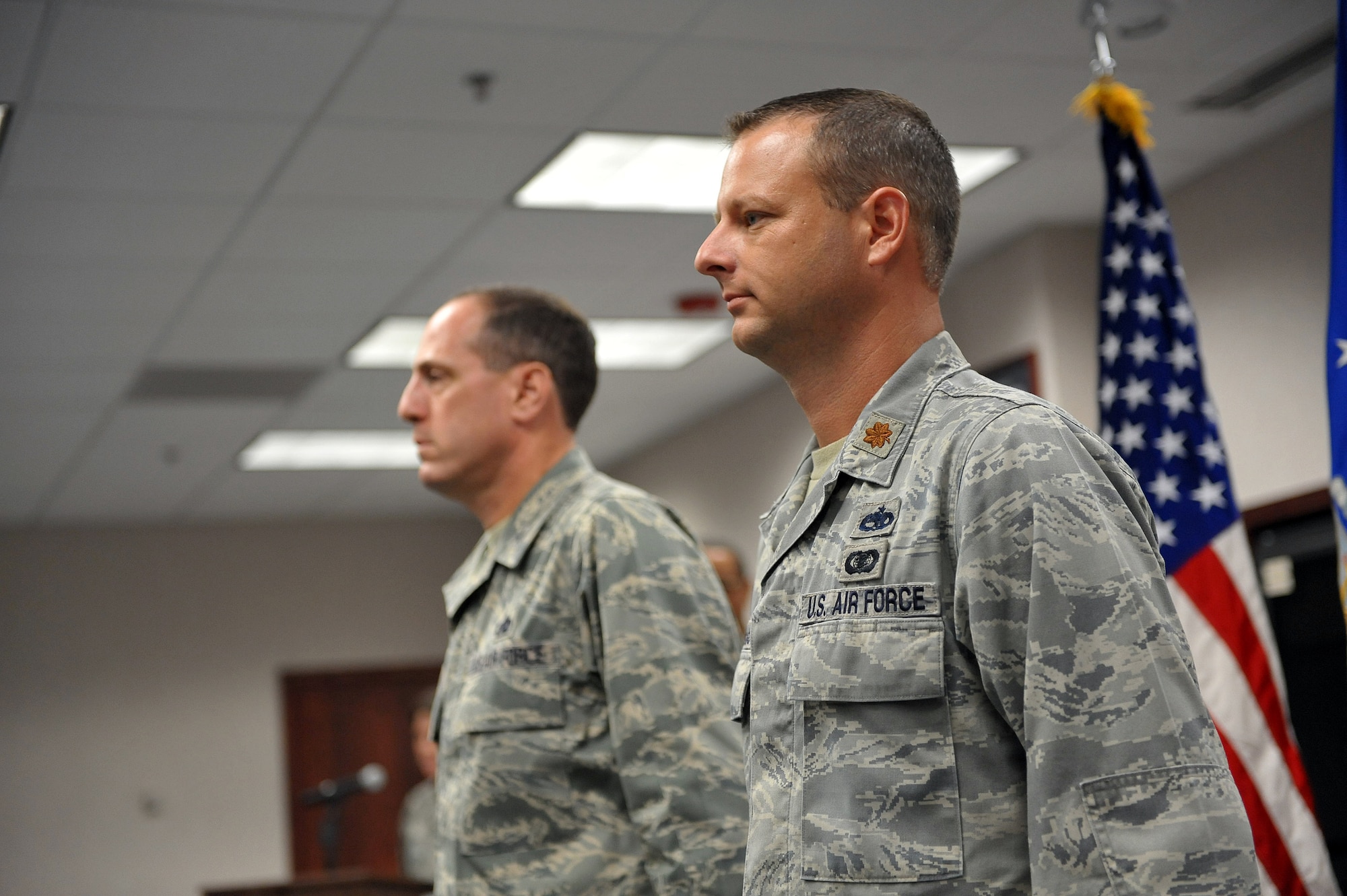 Maj. Wade Cornelius, right, and Brig. Gen. Lee Levy stand at attention at an award eremony where the major received the Bronze Star. U.S. Air Force photo by Tommie Horton.