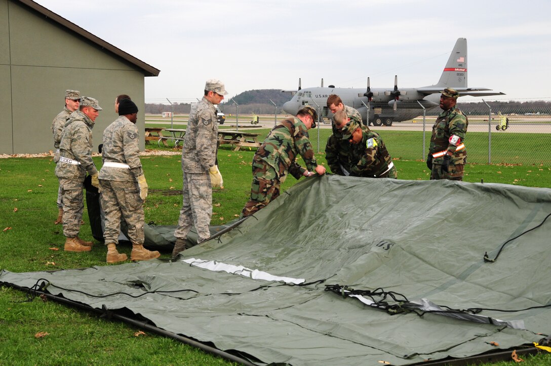 VOLK FIELD, WI - Members of the 165th Airlift Wing, Savannah, Georgia, prepare shelters for an two day Operational Readiness Exercise that simulates operations in a forward deployed location.