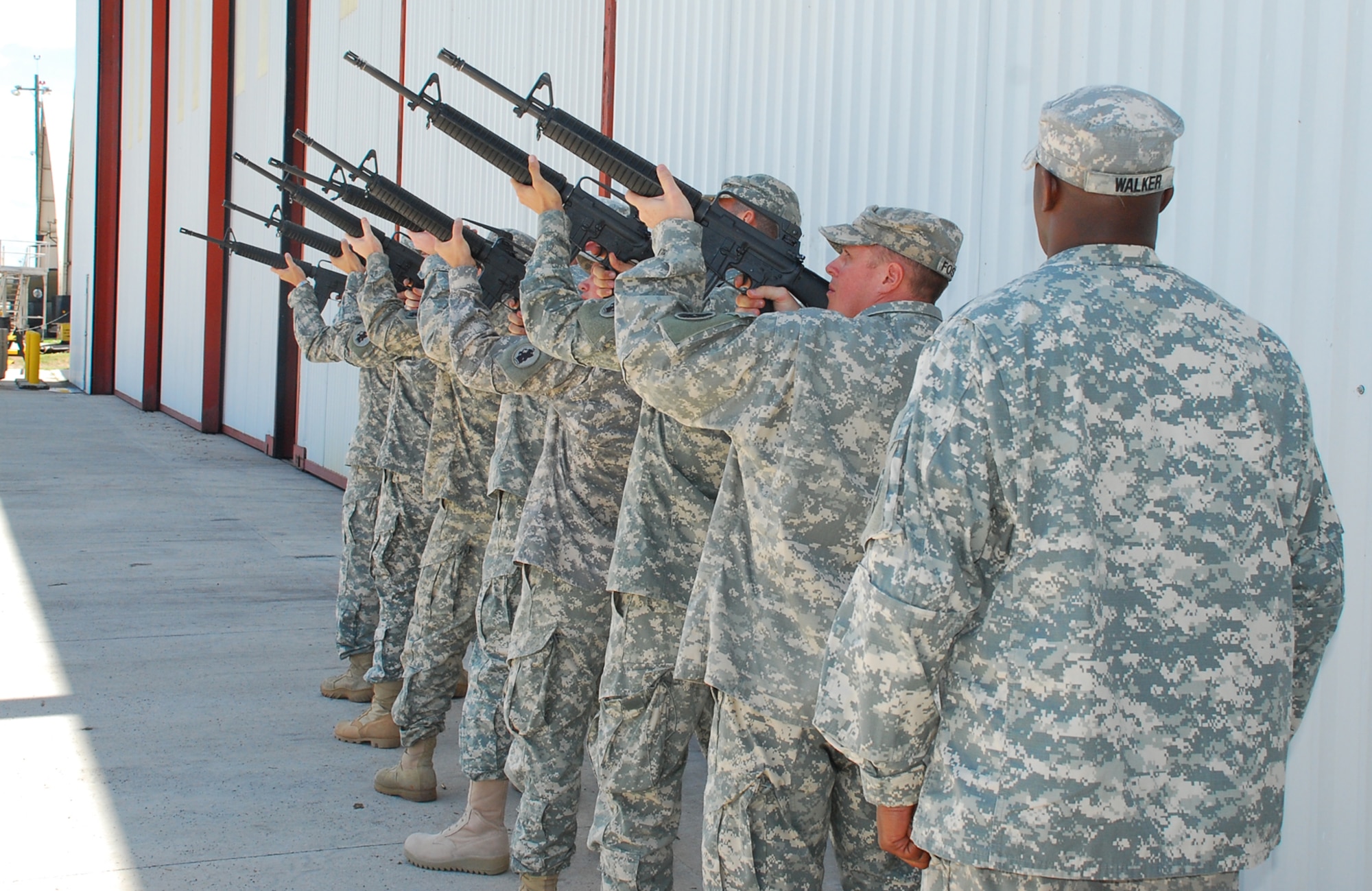 SOTO CANO AIR BASE, Honduras --  Seven Soldiers fire three volleys in honor of two fallen 1-228th Aviation Regiment Soldiers during a memorial ceremony here Aug. 5. Sgt. Leodegario Lizárraga and Sgt. Luis Brito both died in a car accident July 31. (U.S. Air Force photo/Martin Chahin)