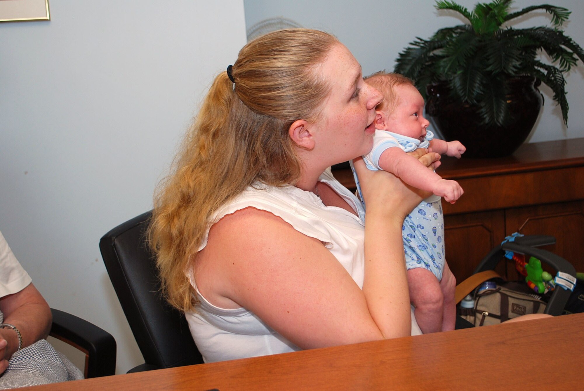 Sabrina Clark holds her son, 5-week-old Spencer Thomas Clark, up so her husband Senior Airman William Clark can see the boy for the first time from halfway around the world at Joint Base Ballad on Tuesday. Sabrina Clark attended a video teleconference (VTC) coordinated by Westover's Airman and Family Readiness Center.