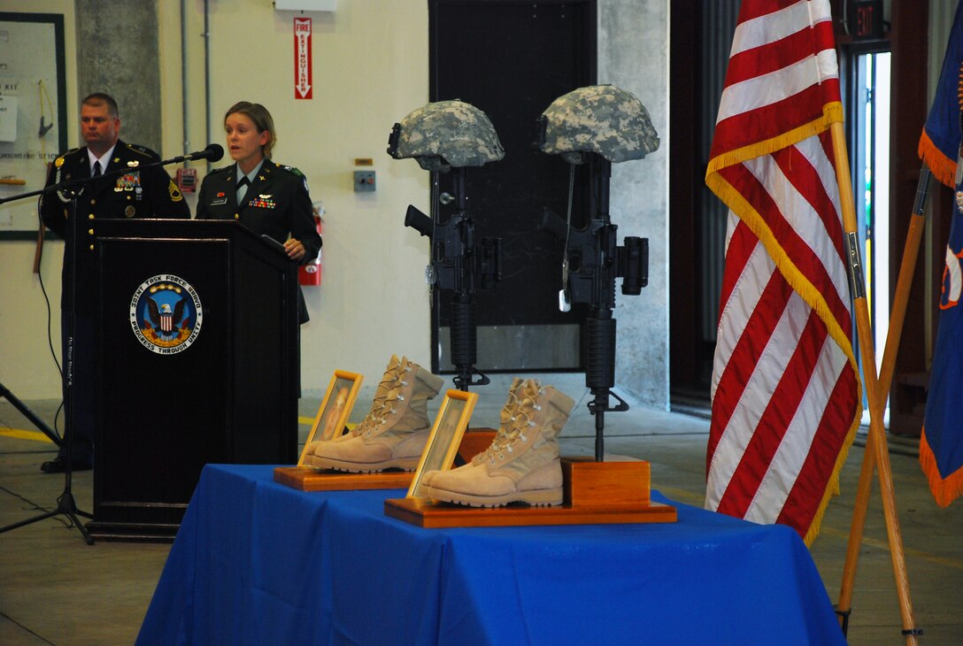 SOTO CANO AIR BASE, Honduras --  Capt. Erica Huston, the 1-228th Aviation Regiment Headquarters and Headquarters Company commander, shares her memories of Sgt. Luis Brito and Sgt. Leodegario Lizárraga during a memorial ceremony here Aug. 5. Sergeants Brito and Lizárraga, both 1-228th Soldiers, died in a car accident July 31. (U.S. Air Force photo/Martin Chahin)