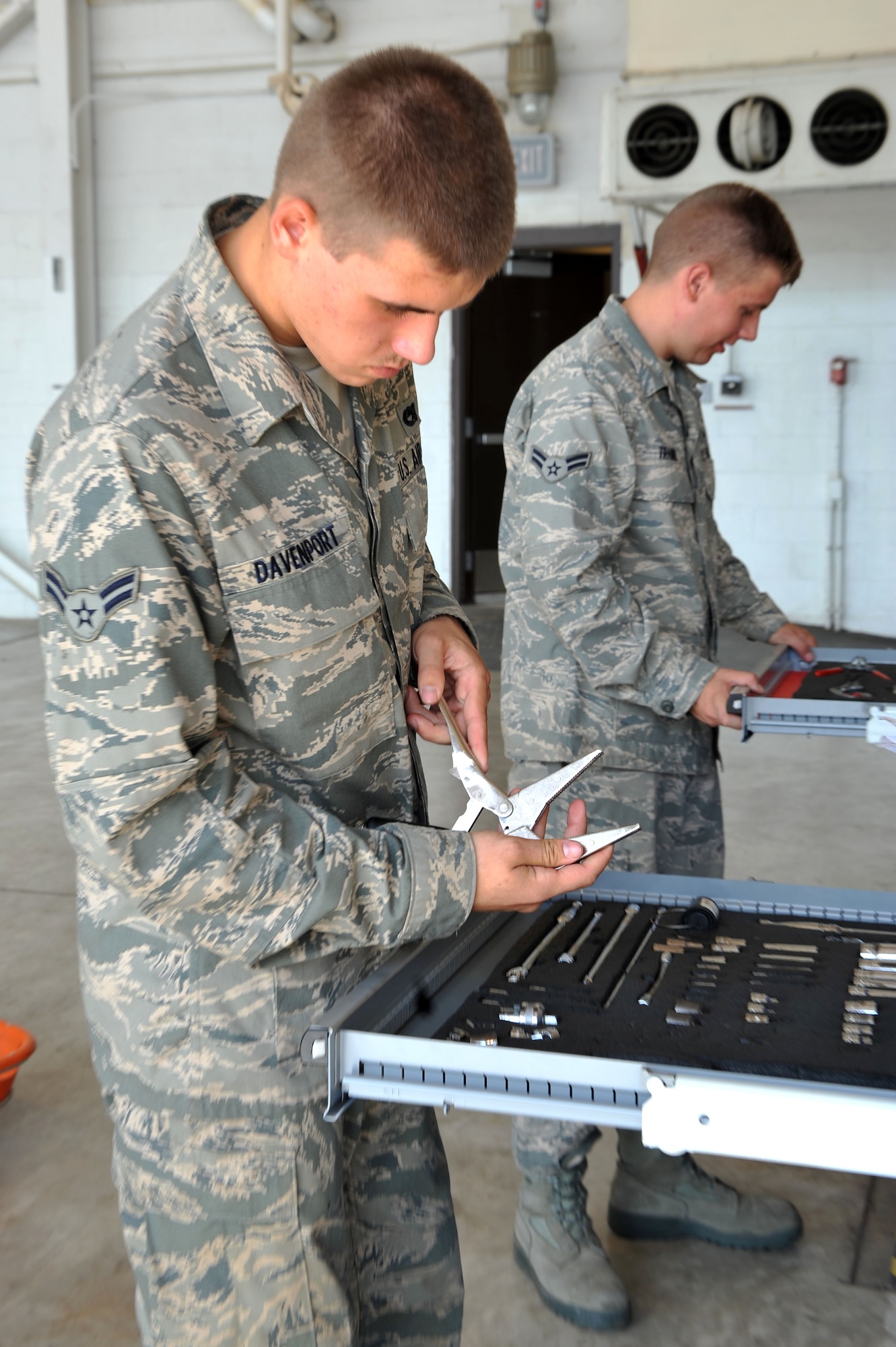 19th Component Maintenance Squadron aircraft fuels systems repair apprentices Airman 1st Class Trenton Davenport (left) and Airman 1st Class James Trainer, choose the right tools for the job July 16. Aircraft fuels systems Airmen ensure accountability and proper care for all equipment while performing daily tasks. (U.S. Air Force photo by Senior Airman Steele C. G. Britton)