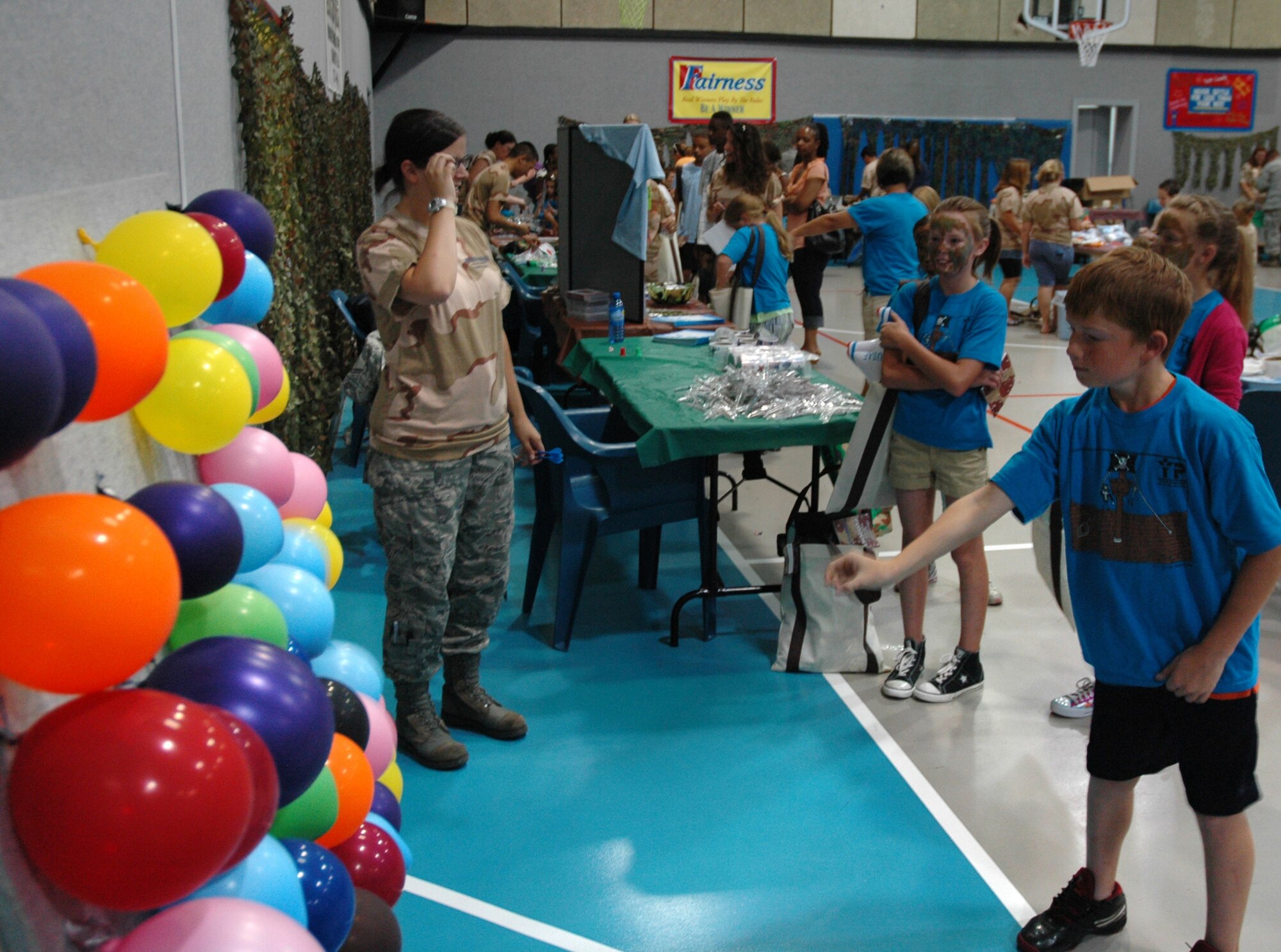 Connor, 9, throws  a dart at a wall of balloons set up by Airman 1st Class Bethany Snisky, 341st Medical Operations Squadron medic, July 30, 2010, inside the Youth Programs Center at Malmstrom Air Force Base, Mont. Airman Snisky said the children didn't win prizes, but got to take a "shot" instead of getting a shot. (U.S. Air Force photo/Senior Airman Dillon White)