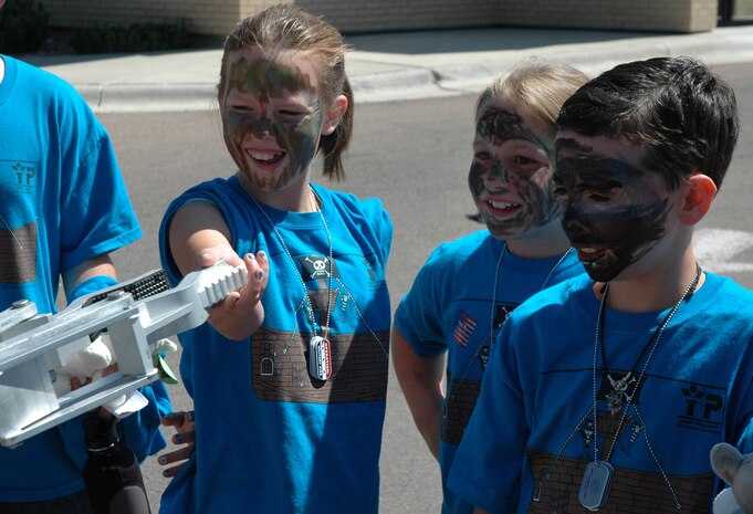 Hannah, 11, shakes hands with F6A, an explosive ordnance disposal robot, operated by Airman 1st Class Mike Medeiros, assigned to 341st Civil Engineer Squadron EOD, July 30, 2010, at the Youth Programs Center at Malmstrom Air Force Base, Mont. Amanda, 9, and Brandon, 11, were next in line to meet the bomb-disarming machine. (U.S. Air Force photo/Senior Airman Dillon White)