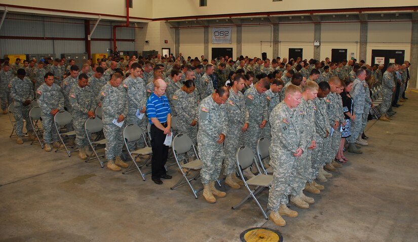 SOTO CANO AIR BASE, Honduras --  Members of Joint Task Force-Bravo bow their heads in prayer during the memorial ceremony for two 1-228th Aviation Regiment Soldiers here Aug. 5. Sgt. Luis Brito and Sgt. Leodegario Lizárraga died in a car accident July 31. (U.S. Air Force photo/Martin Chahin)