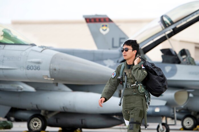NELLIS AIR FORCE BASE, Nev. -- Capt. Lloyd Lin, Republic of Singapore Air Force pilot walks to his F-16CG aircraft parked on the Nellis flight line, July 26, 2010 during Red Flag 10-4. The RSAF is stationed at Luke AFB, pilots and maintenance personnel are assigned to the 425th Fighter Squadron for two years, during which they receive advanced tactics training by participating in Red Flag exercises. (U.S. Air Force photo/Lawrence Crespo) 



