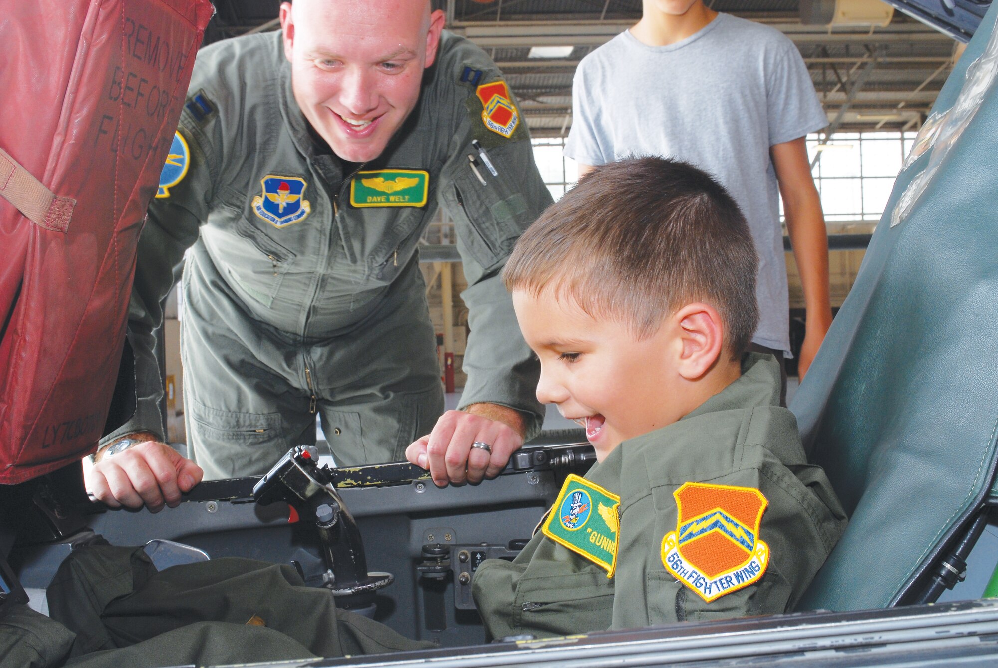 Pilot-for-a-day Trevor "Gunner" Collins, 5, shows his  excitement while sitting in the cockpit of an F-16 Fighting Falcon assigned to the 310th Fighter Squadron, 56th Fighter Wing on July 29th in Hangar 913 during his tour of Luke Air Force Base, Arizona.  (U.S. Air Force photo/Senior Airman Tracie Forte)