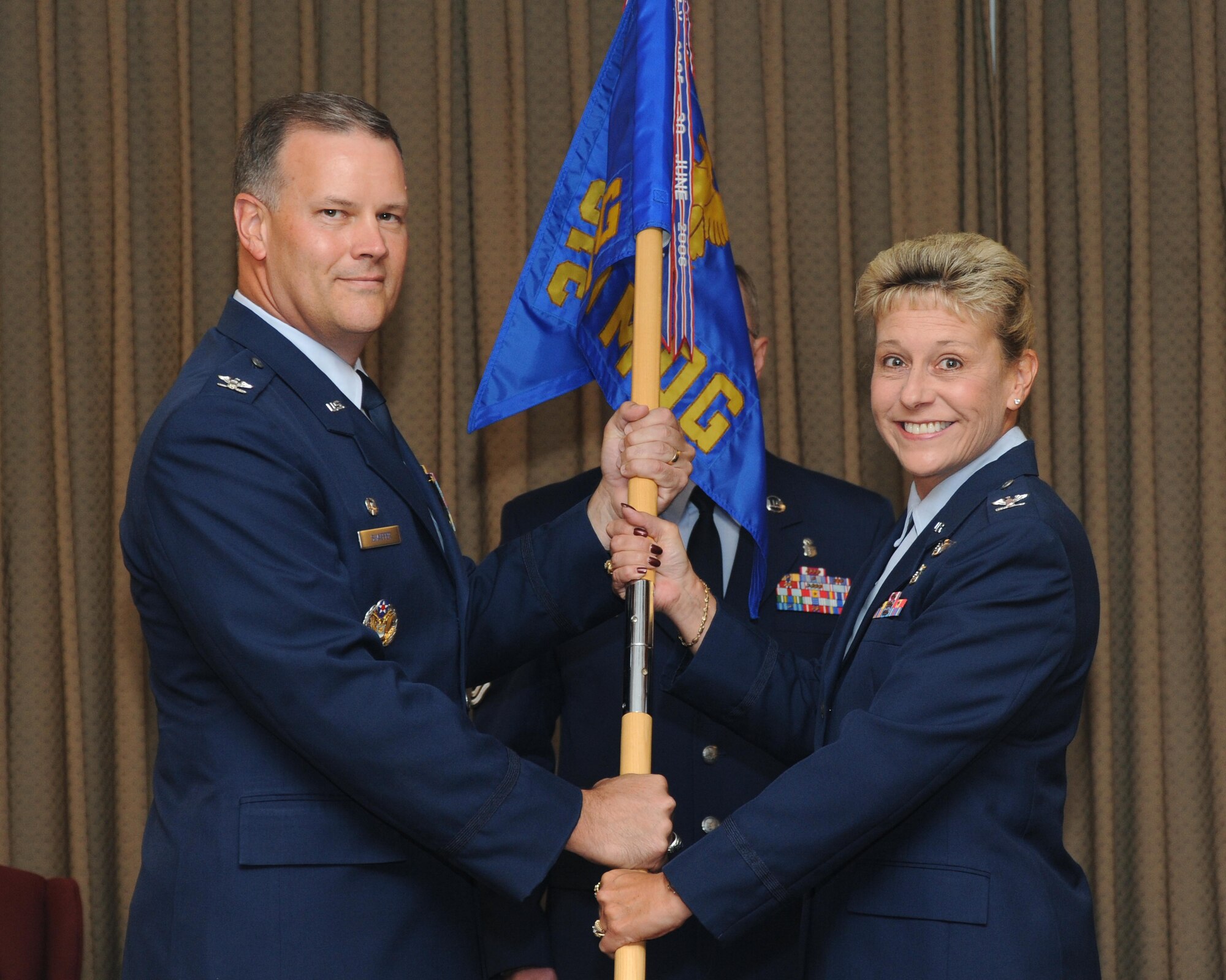 Col. Jane Denton (right) assumes command of the 319th Medical Group from Col. Don Shaffer, 319th Air Refueling Wing commander, during a change-of-command ceremony, Aug. 5 at the Northern Lights Club. Colonel Denton assumed command of the 319th MDG from Col. Kathleen Concannon. (U.S. Air Force photo by Tech. Sgt. Johnny Saldivar)  
