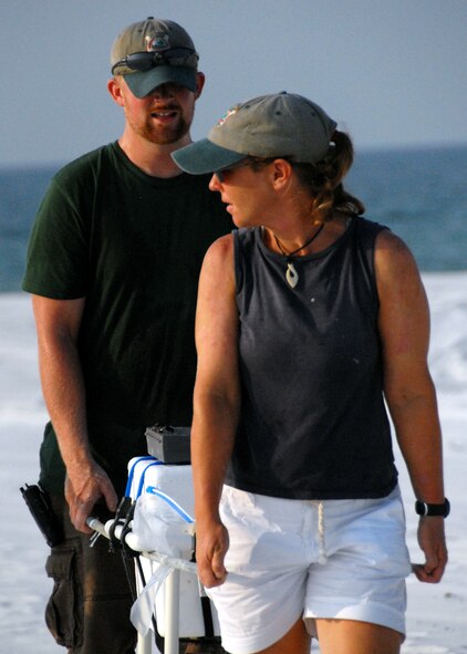 Kathy Gault and Dusty Varble, 96th Civil Engineer Squadron biologists, carry out a cooler filled with sea turtle eggs after carefully removing them from their nest on an Eglin Air Force Base, Fla., beach Aug. 2. The eggs will be transported to the East Coast so the turtles can be released without the threat of encountering oil from the spill in the Gulf of Mexico. The group of biologists removed 117 eggs from the nest on this day and more than 300 eggs have been moved so far. (U.S. Air Force photo/Samuel King Jr.) 