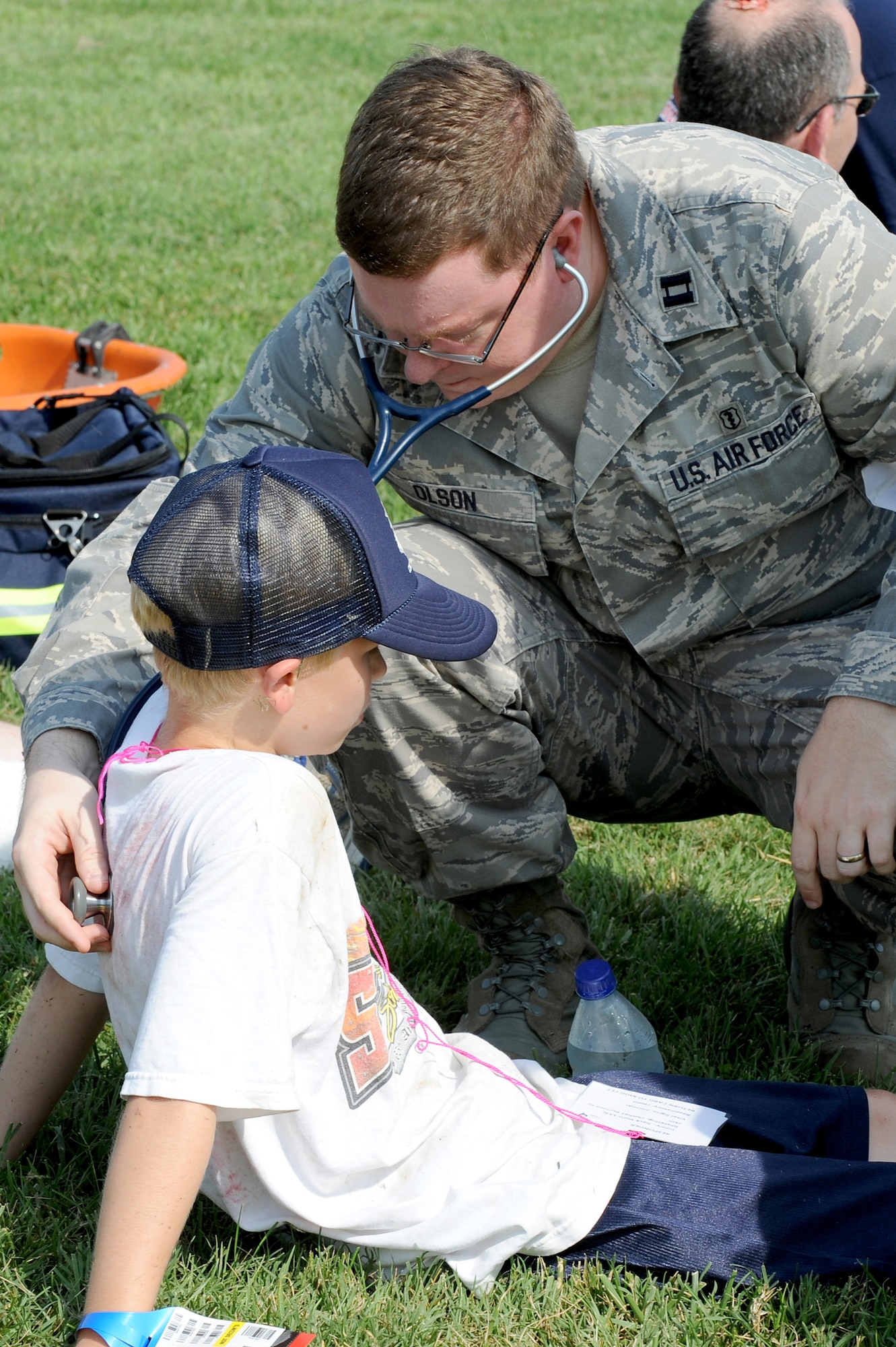 Capt. Kevin Olson, 375th Medical Operations Squadron, checks the vital signs of a “victim” of a simulated crash scene during a Major Accident Response Exercise at Scott AFB, August 3, 2010. The exercise was conducted in preparation for the upcoming air show on September 11-12. It tested emergency teams' capability to respond and control a crash scene in the event of a real world incident. (U.S. Air Force photo by Staff Sgt. Brian J. Ellis)