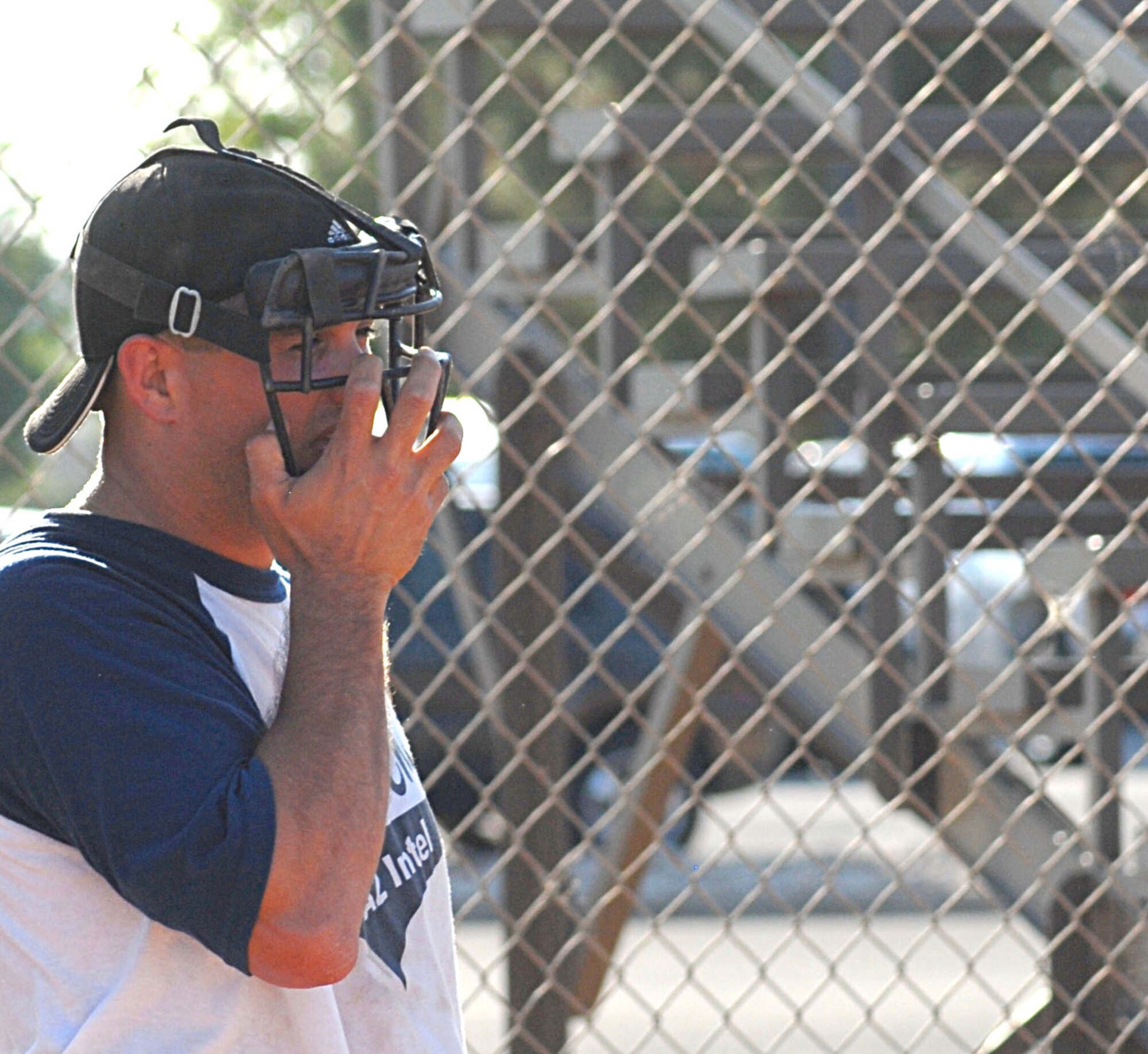 315th Training Squadron catcher Kendal Beasley examines the outfield during the 2010 Intramural Softball championship game against the 17th Mission Support Group Aug. 4. After a doubleheader, the 17 MSG defeated 315 TRS, 15-12, taking the base championship. (U.S. Air Force photo/Connie Hempel)