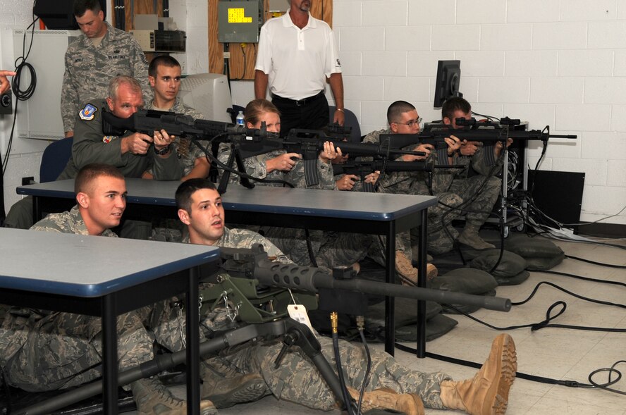 SEYMOUR JOHNSON AIR FORCE BASE, N.C. -- Maj. Gen. William Holland fires a M-240B during a engagement skills trainer demonstration at the 4th Security Forces Squadron here Aug. 3, 2010. After the demo, the general spoke to the Airmen about their deployment experiences and the importance of the training they receive prior to leaving. General Holland is the commander, 9th Air Force, Air Combat Command, Shaw Air Force Base, S.C. (U.S. Air Force photo/Staff Sgt. Courtney Richardson)
