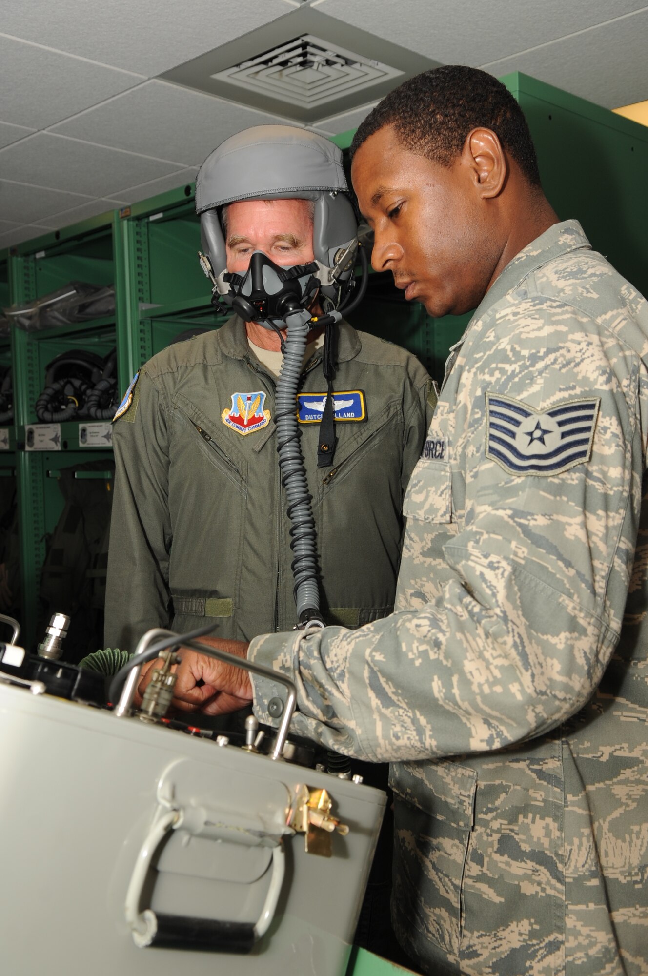 SEYMOUR JOHNSON AIR FORCE BASE, N.C. – Tech. Sgt. Clint Haynes  tests Maj. Gen. William Holland’s mask for leaks prior to his flight in an F-15E Strike Eagle here Aug. 3, 2010. In addition to his flight with the 335th Fighter Squadron, General Holland also visited Airmen at the 4th Medical Group, 4th Security Forces Squadron, 4th Maintenance Group, the fitness center and the Personnel Deployment Facility. Sergeant Hayes, 335th Fighter Squadron aircrew flight equipment craftsman, hails from Compton, Calif. General Holland is the commander, 9th Air Force, Air Combat Command, Shaw Air Force Base, S.C. (U.S. Air Force photo /Staff Sgt. Courtney Richardson)