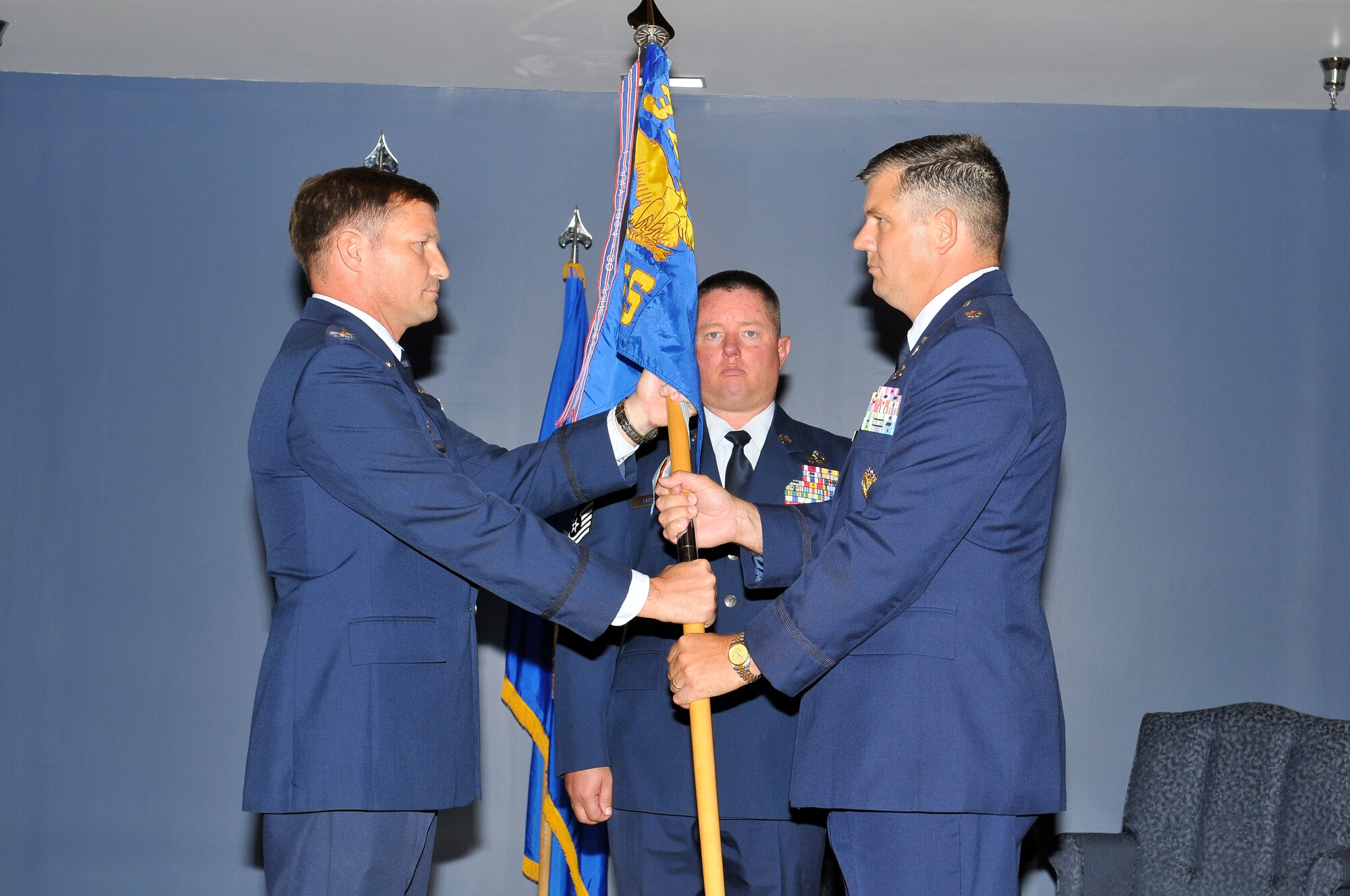 Lieutenant Col. Douglas Gilpin accepts the 325th Civil Engineer Squadron guidon from Col. Michael Fleck, 325th Mission Support Group commander, during a Change of Command ceremony July 22 at Tyndall. Colonel Gilpin replaces Lt. Col. Keith Welch as the new 325th CE commander. (U.S. Air Force photo/Lisa Norman)