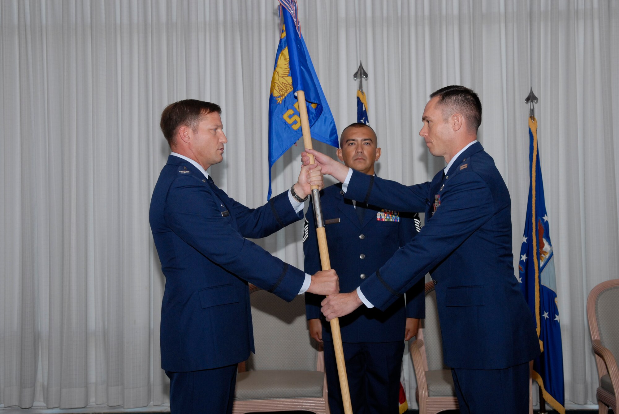 Captain Jeffrey Adams accepts the 325th Security Forces Squadron guidon from Col. Michael Fleck, 325th Mission Support Group commander, during a Change of Command ceremony July 30 at Tyndall. Captain Adams replaces Maj. David Boyd as the new 325th SFS commander. (U.S. Air Force photo/Susan Trahan)