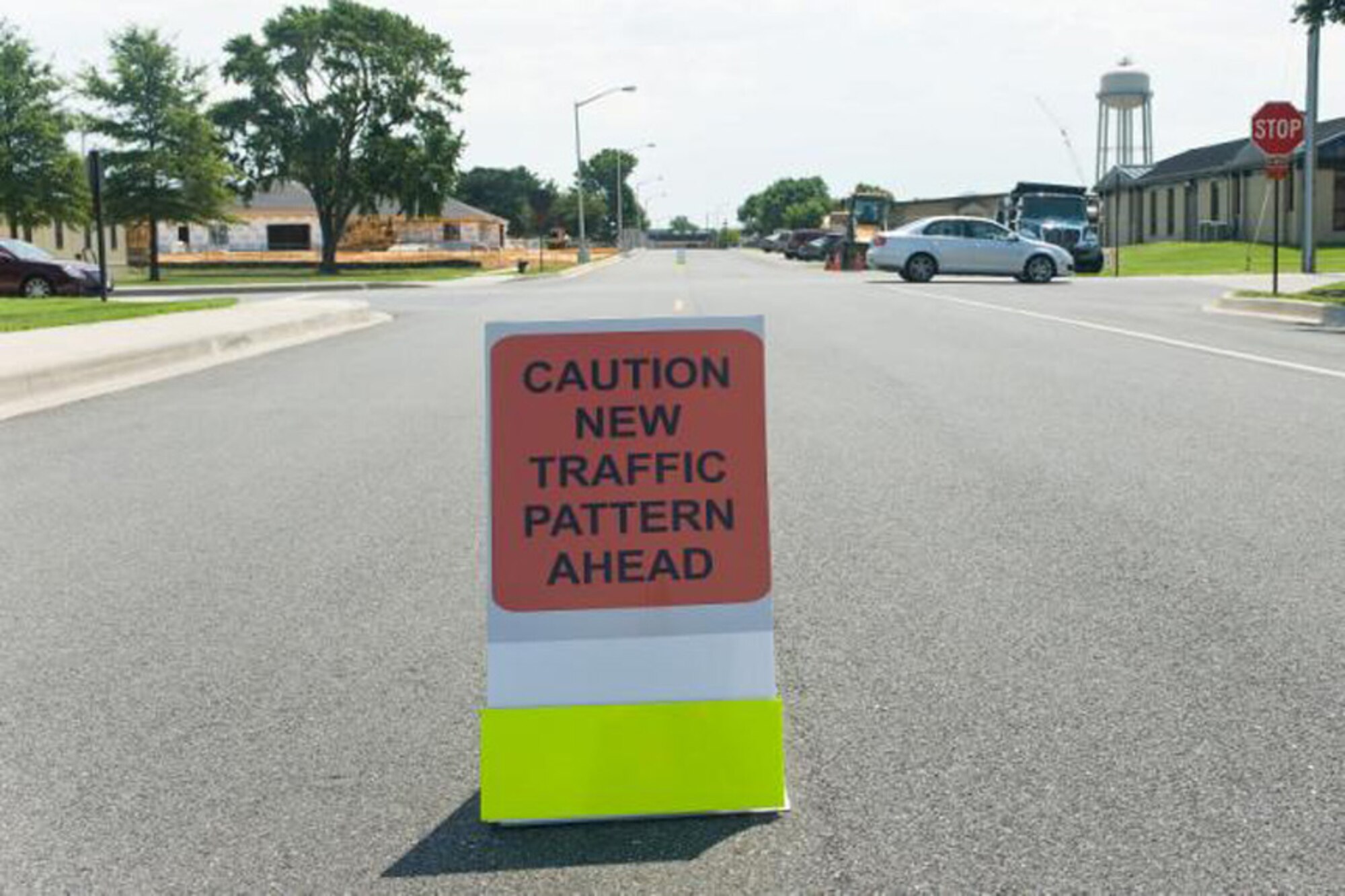 A sign warning drivers of a new four-way stop sign sits in the road near the corner of Eagle Way and Tuskegee on Dover Air Force Base, Del., Aug. 5, 2010. The new four-way stop sign should help drivers and traffic near the medical center on base. (U.S. Air Force photo by Roland Balik/Released)