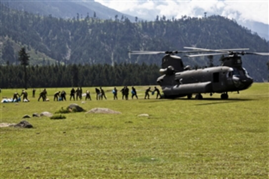 Members of the Pakistani military unload sacks of grain from the back of a U.S. Army CH-47 Chinook helicopter in Pakistan, Aug. 5, 2010. The grain will be delivered to residents in Khyber Pakhtunkhwa, Pakistan, as part of the disaster relief efforts to assist Pakistanis in the nation's flood-stricken regions.