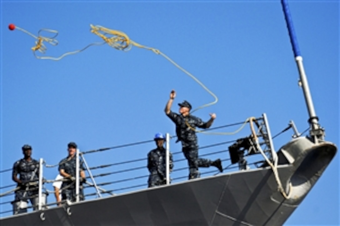 A U.S. Navy sailor aboard the guided-missile destroyer USS McFaul heaves a line as the ship returns to Naval Station Norfolk, Va., Aug. 3, 2010. The McFaul is deployed with the Dwight D. Eisenhower Carrier Strike Group.