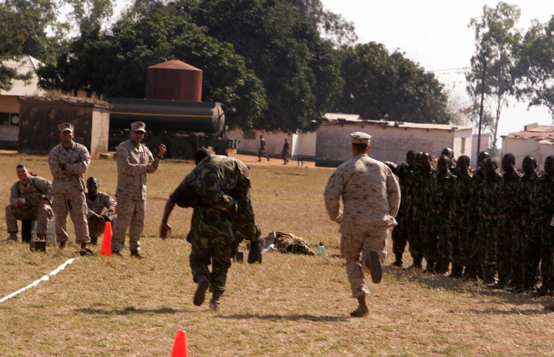 A soldier with the Armed Forces for the Defense of Mozambique fireman carries another FADM soldier during a Marine Combat Fitness Test in Moamba, Mozambique, Aug. 6. The FADM soldiers ran the test as part of Exercise SHARED ACCORD 2010. SHARED ACCORD is an annually scheduled, bi-lateral U.S.-Mozambique field training exercise aimed at conducting small unit infantry and staff training with U.S. Africa Command partner nations.  The exercise is designed to increase partner nation capacity for conducting peace and stability operations. The exercise is scheduled to conclude on Aug. 13. All U.S. forces will return to their home bases in Europe and the U.S. at the end of the exercise.::r::::n::