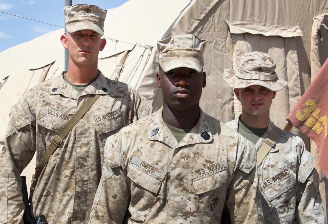 From left to right, Staff Sgt. Luke Gilliland, a platoon sergeant from Phoenix, Ariz., Seaman Markie Smith, a corpsman from Syracuse, N.Y., and Lance Cpl. Bradley Thornburg, a gunner from Dallas, Tex., all with 1st Platoon, Bravo Battery, 3rd Low Altitude Air Defense Battalion, were all part of a squad which came to the rescue for a 10-year-old Afghan boy who was suffering from third degree burns over his back and right arm.  The boy was ultimately treated on scene, then transferred later to Camp Bastion Hospital where he ultimately received a skin graft.