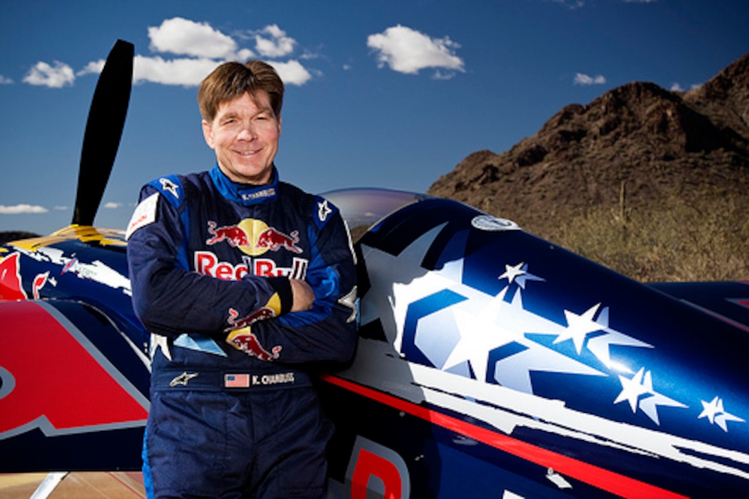 Bull flyer Kirby Chambliss  poses in front of his plane.