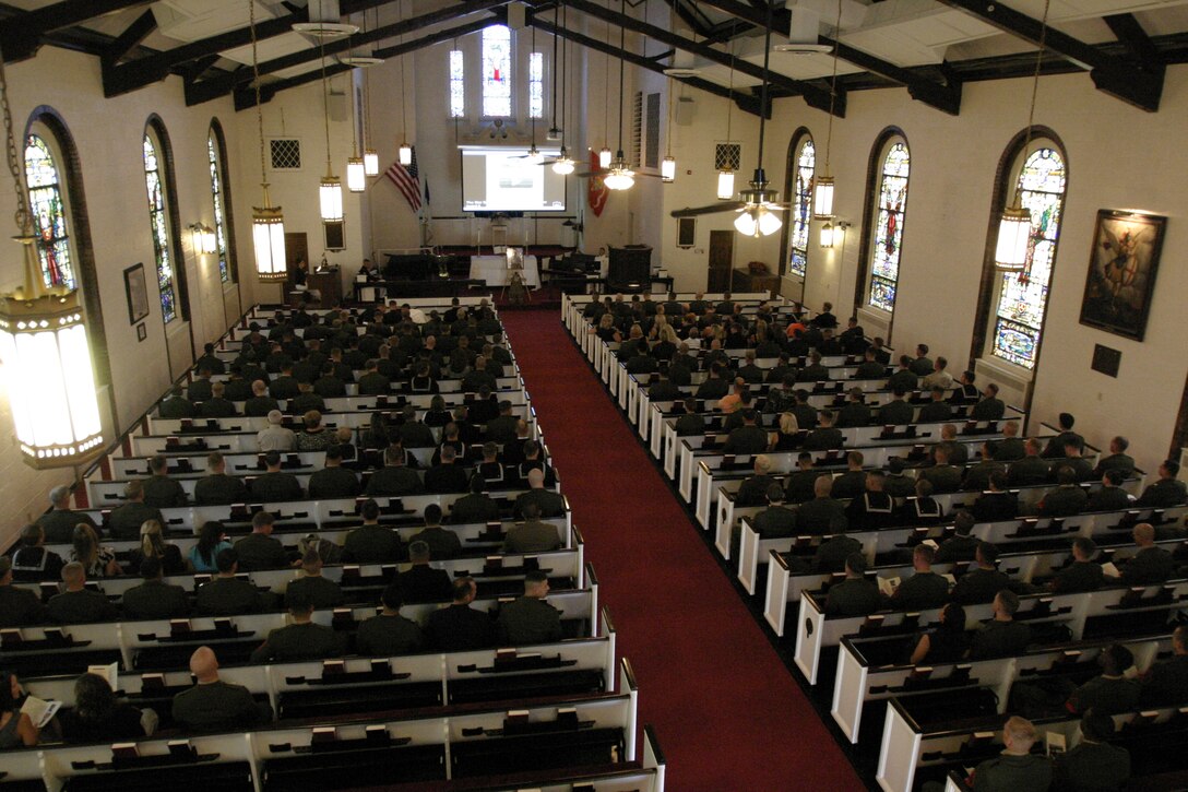Marines, Sailors and civilians at Gunnery Sgt. Robert Gilbert II’s memorial service fill the pews of the Protestant Chapel. Robert Jr. died March 16 of wounds sustained during combat operations in Afghanistan.