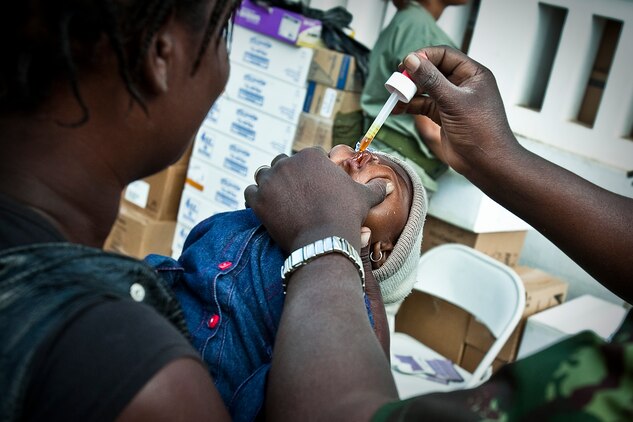 A Mozambican woman holds here newborn baby as a doctor with the Mozambican military gives medicine to the child Aug. 7, 2010. Service members with Marine Forces Africa and Marine Forces Reserve set up medical clinics during exercise Shared Accord 2010, a 10-day exercise designed to build U.S. Africa Command partner nation capacity for peace and stability operations.