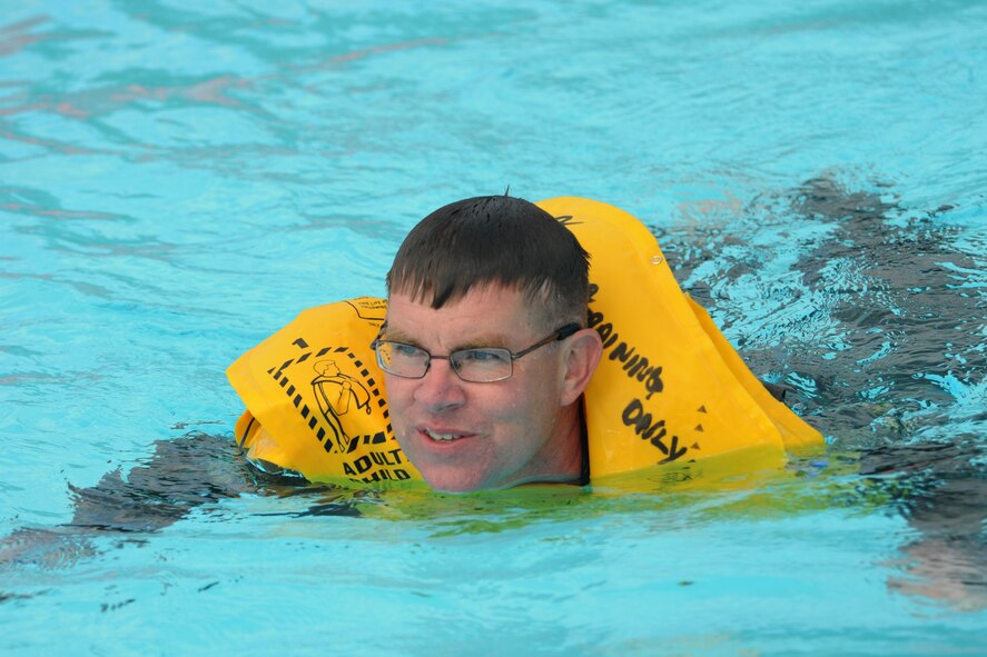 Master Sergeant John E. Lennon Junior swims during survival training at the Pierce Island Pool in Portsmouth, New Hampshire on August 7, 2010.  This is a tri-annual requirement which consists of combat survival, water survival, and equipment familiarization. Lennon is an inflight refueling specialist assigned to the 133rd Air Refueling Squadron here at Pease. (U.S. Air Force photo/Staff Sgt. Curtis J. Lenz)