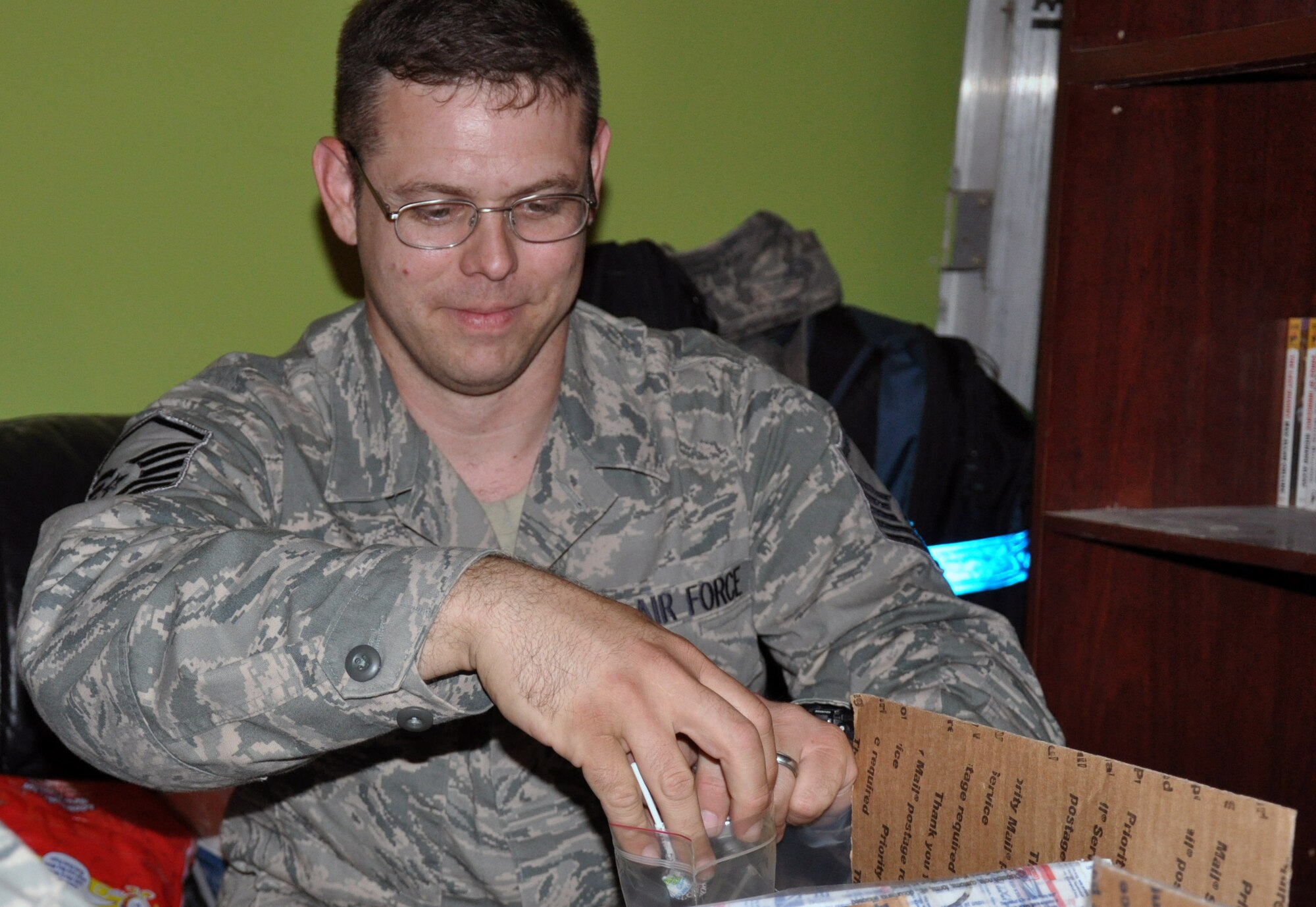 Master Sgt. Steven Bonin, 447th Expeditionary Logistics Readiness Squadron, fills bags with candy as part of a care package for one of the children of an Iraqi soldier as part of the Good Neighbor Program.  This program is an initiative designed to provide care packages for the families of Iraqi soldiers stationed in the area and to build stronger relationships between members of the U.S. and Iraqi militaries.  Originally started by junior enlisted volunteers from Sather Air Base, Baghdad, the GNP volunteer force has spread to all ranks and services throughout the Victory Base Complex and the Baghdad area.  (U.S. Air Force photo by Tech. Sgt. Mike Edwards)