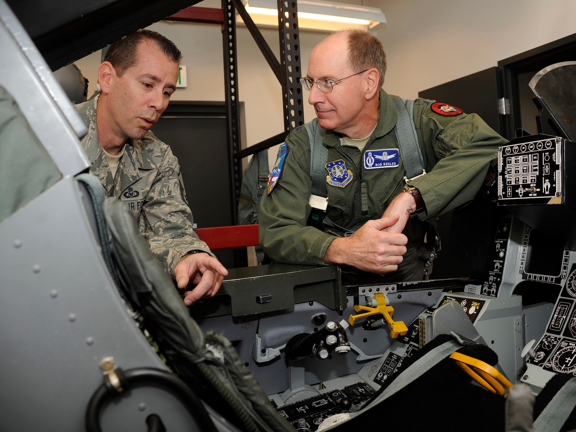 Master Sgt. Greg Roark, 120th Fighter Squadron Life Support NCOIC, explains emergency egress procedures to Gen. C. Robert Kehler, Air Force Space Commander, prior to his F-16 flight with the Colroado Air National Guard.  Gen Kehler spent the day learning about the missions of the Colorado Air National Guard as well as spending time with Airmen from the 460th Space Wing at Buckley Air Force Base.