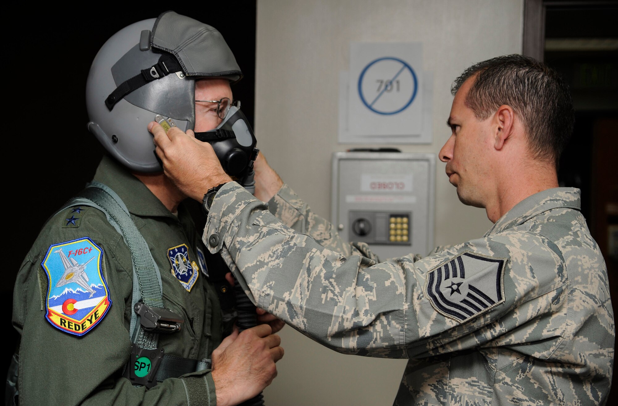 Master Sgt. Greg Roark, 120th Fighter Squadron Life Support NCOIC, fits Gen. C. Robert Kehler, Air Force Space Commander, in his helmet and face mask prior to an F-16 flight with the Colorado Air National Guard.  Gen Kehler spent the day learning about the missions of the Colorado Air National Guard as well as spending time with Airmen from the 460th Space Wing at Buckley Air Force Base.