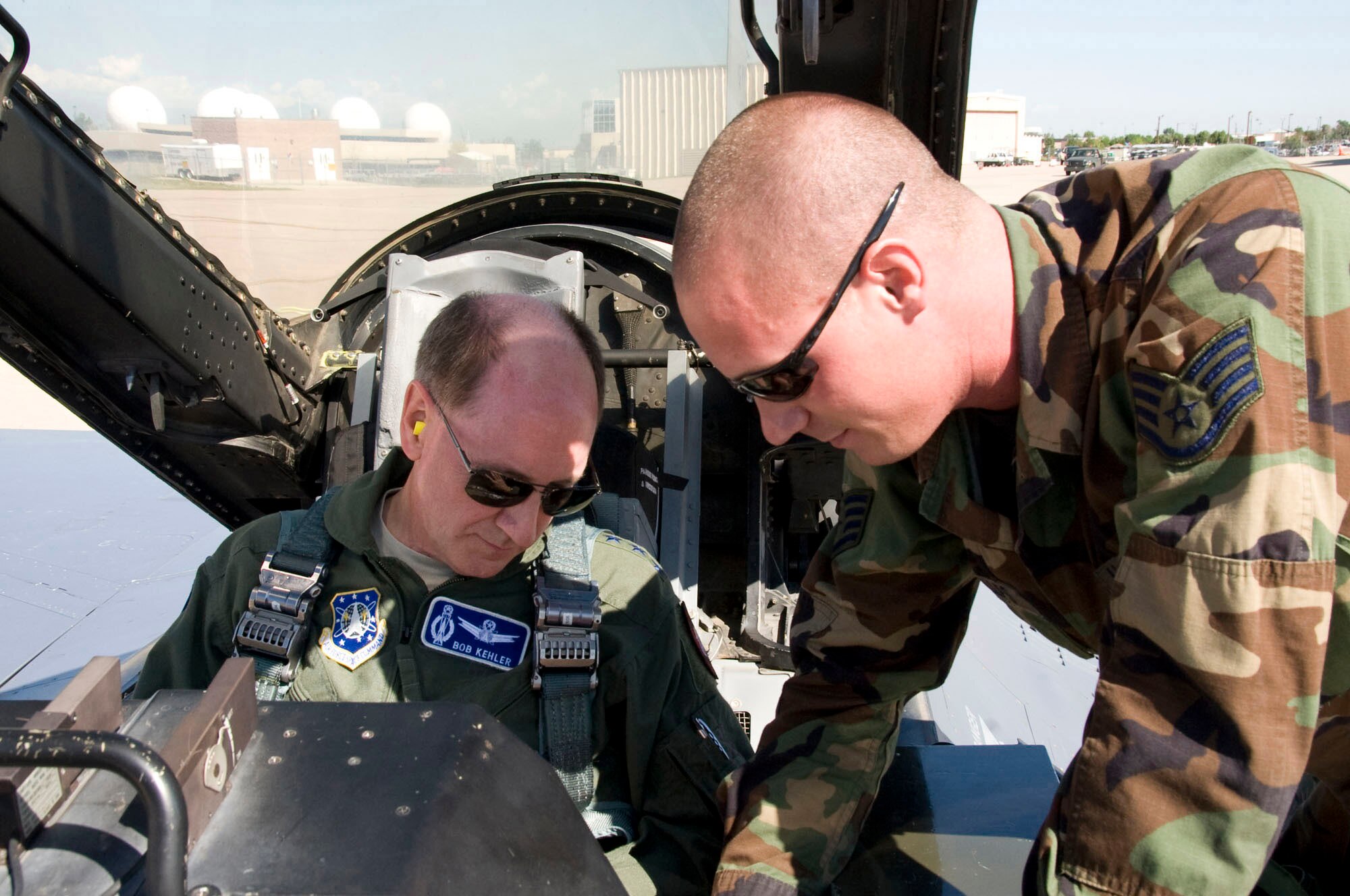 Tech Sgt Jared Phillips, 140th Maintenance Group crew chief, explains last-minute flight procedures prior to takeoff.  Gen Kehler spent the day learning about the missions of the Colorado Air National Guard as well as spending time with Airmen from the 460th Space Wing at Buckley Air Force Base.